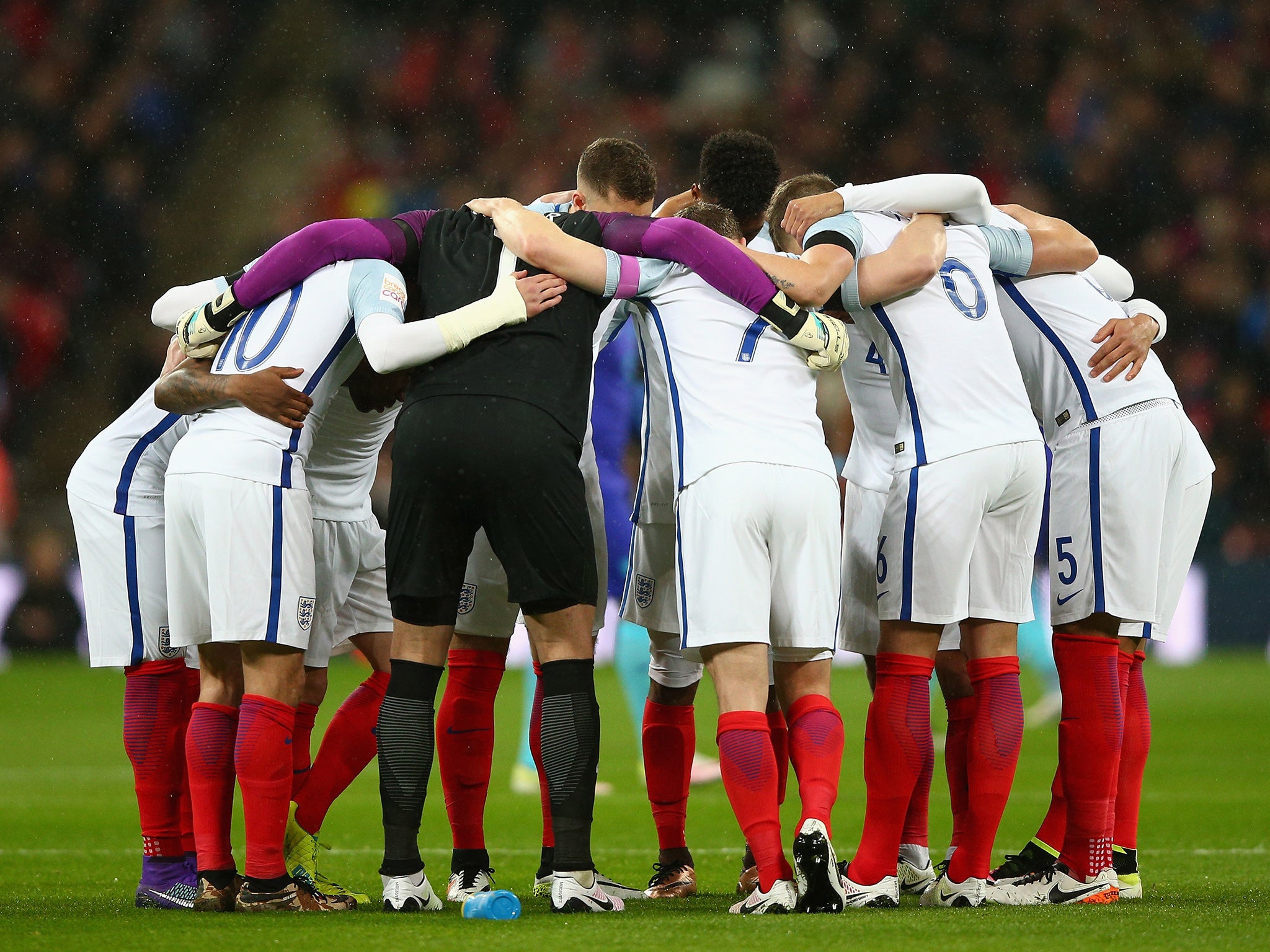 The England team embrace before kick-off