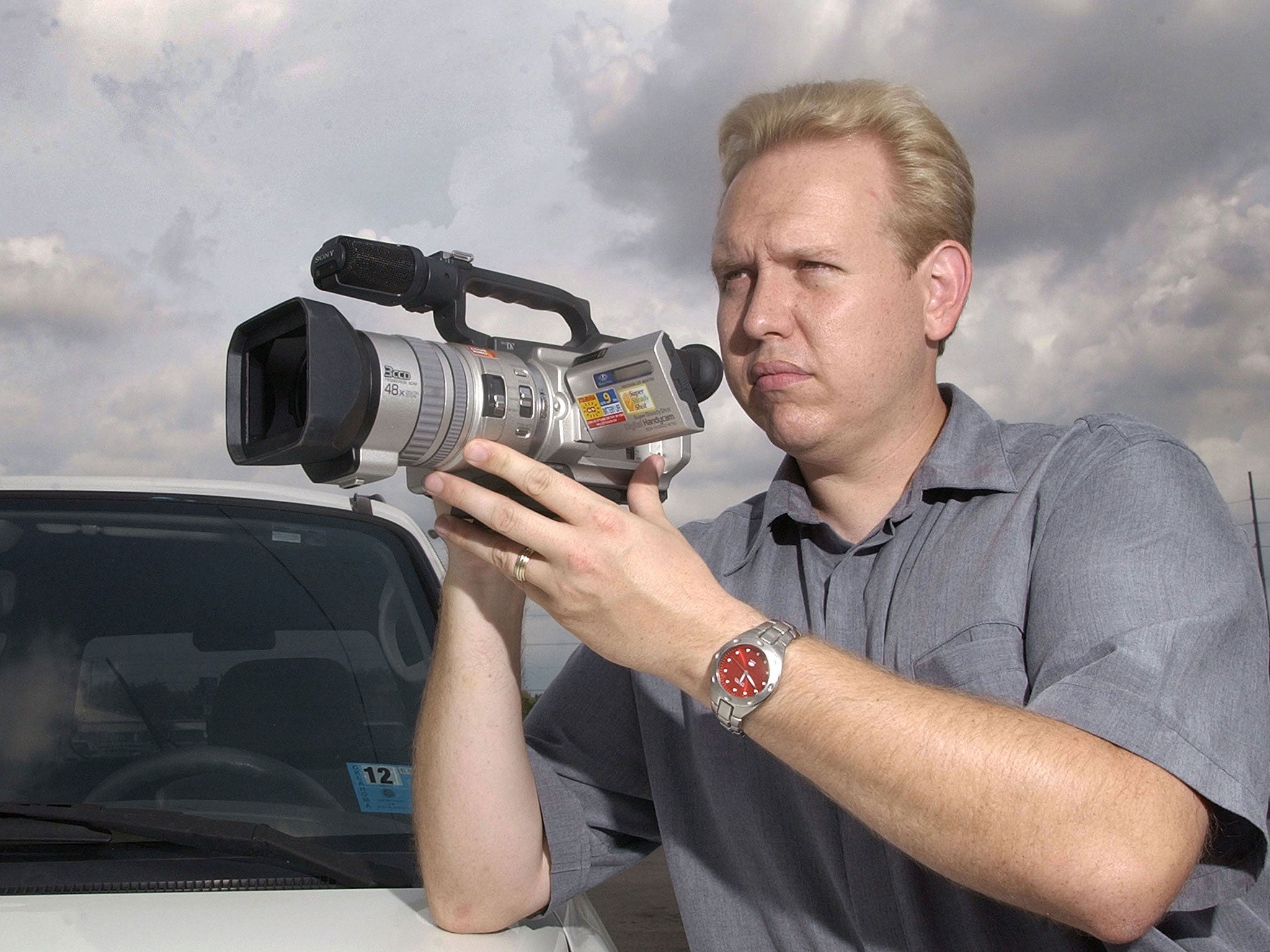Brian Bates, known as the 'Video Vigilante,' is seen in a southeast Oklahoma City neighbourhood 12 July, 2002