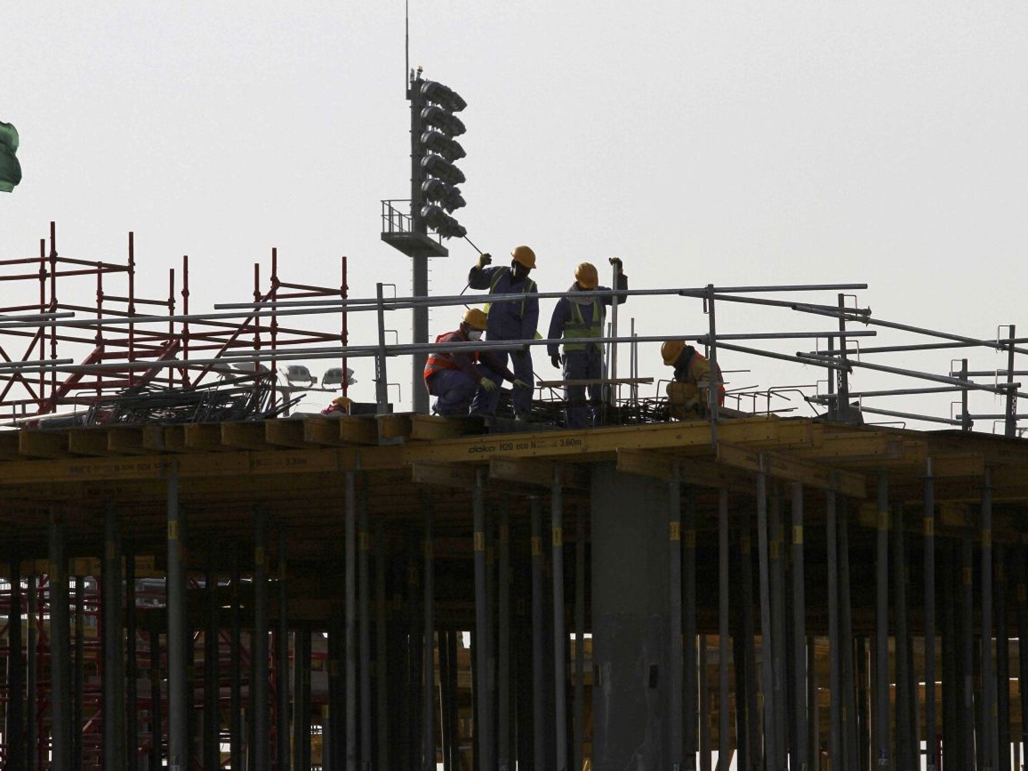 Migrant labourers work at a construction site at the Aspire Zone in Doha, Qatar, 26 March, 2016