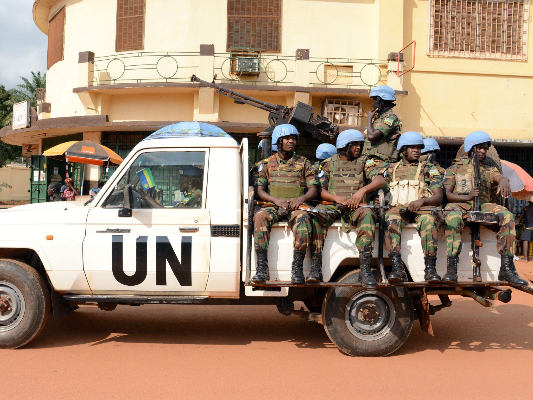 UN peacekeeping soldiers from Rwanda patrol on December 09, 2014 in Bangui.