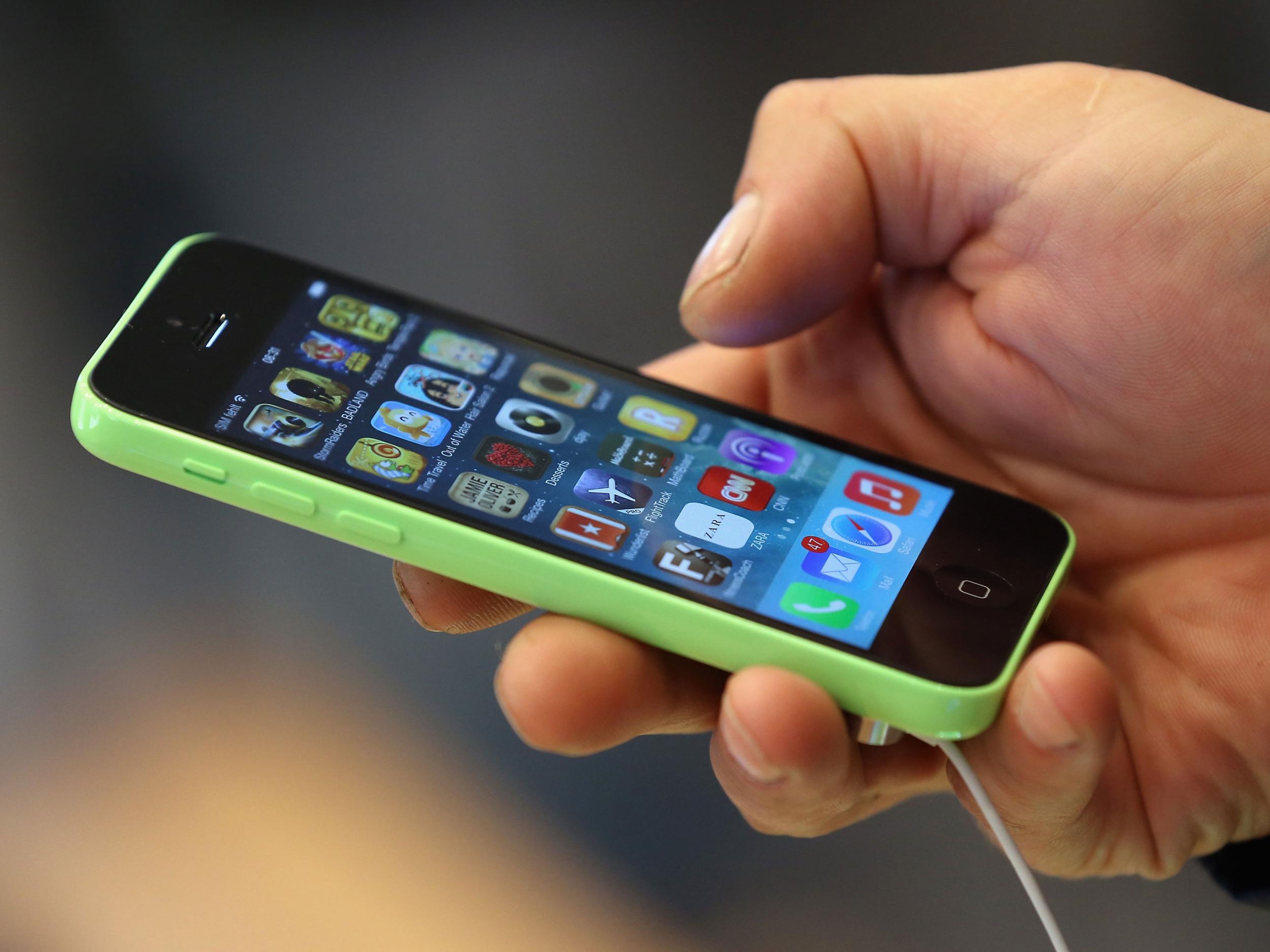 A man uses an iPhone 5C at the Berlin Apple Store