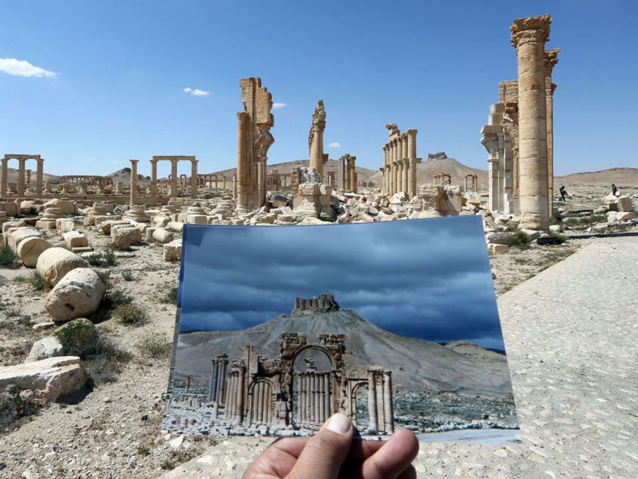 A picture of the Arc du Triomphe (Triumph's Arch) contrasted with what remains of the historic monument after it was destroyed by Islamic State (IS) group jihadists in October 2015 in the ancient Syrian city of Palmyra. (JOSEPH EID/AFP/Getty Images)