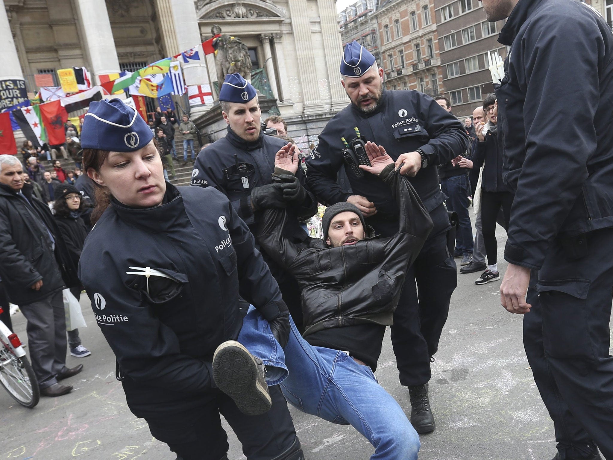 Belgian police arrest protesters at Place de la Bourse at a conter-protest to a planned far-right rally in Brussels, Belgium, 2 April 2016.