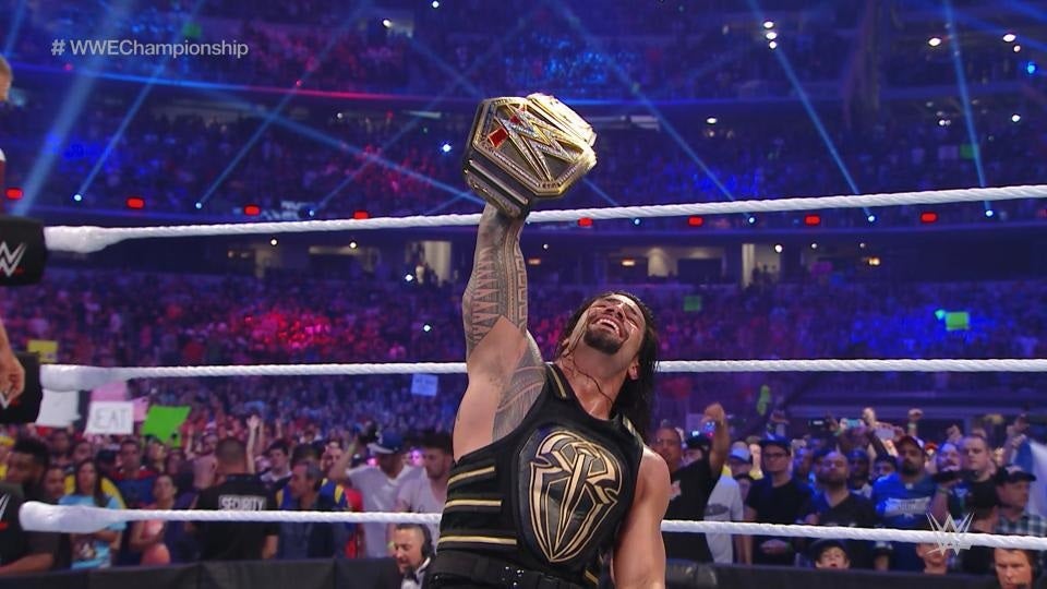 Roman Reigns celebrates his victory at WrestleMania over Triple H