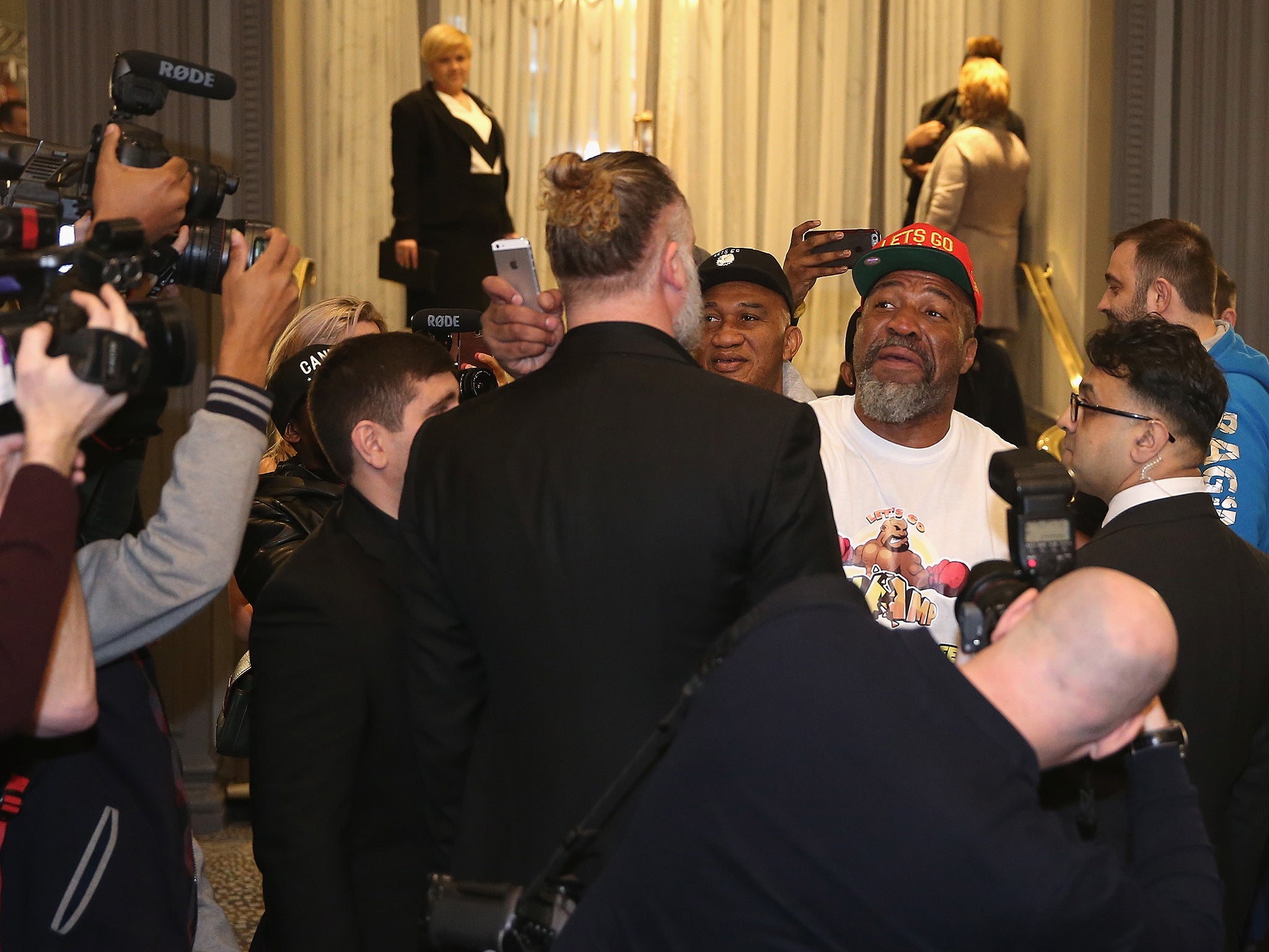 Shannon Briggs, in the white t-shirt and red hat, gatecrashes a David Haye press conference