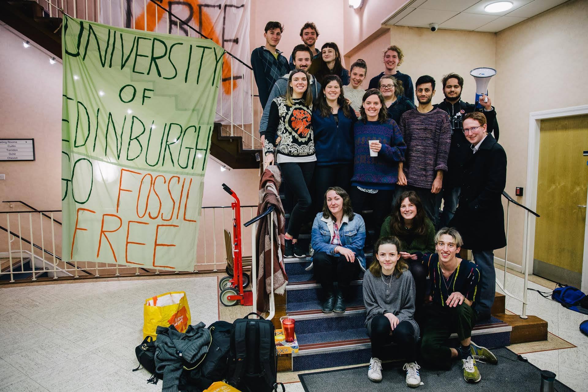 The protesters, pictured, move into the building