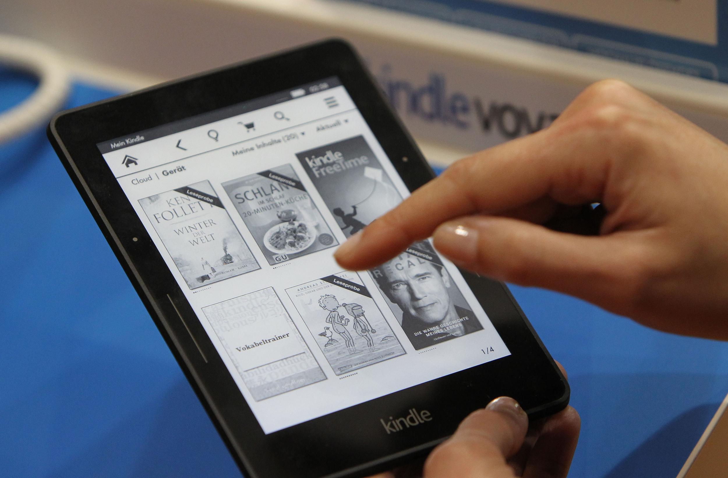 A woman uses the Amazon Kindle at a book fair