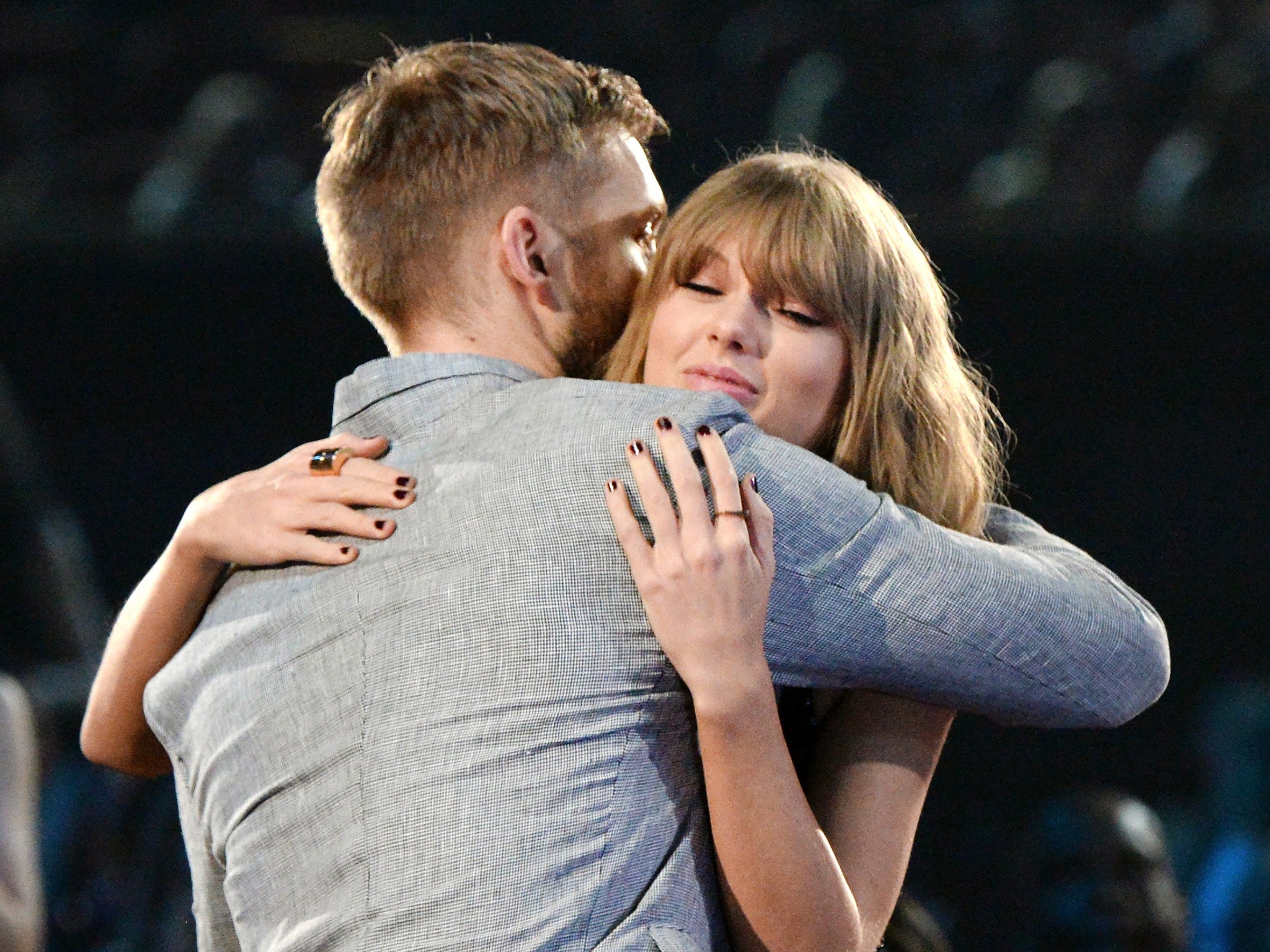 Calvin Harris and Taylor Swift hug during the iHeartRadio Music Awards