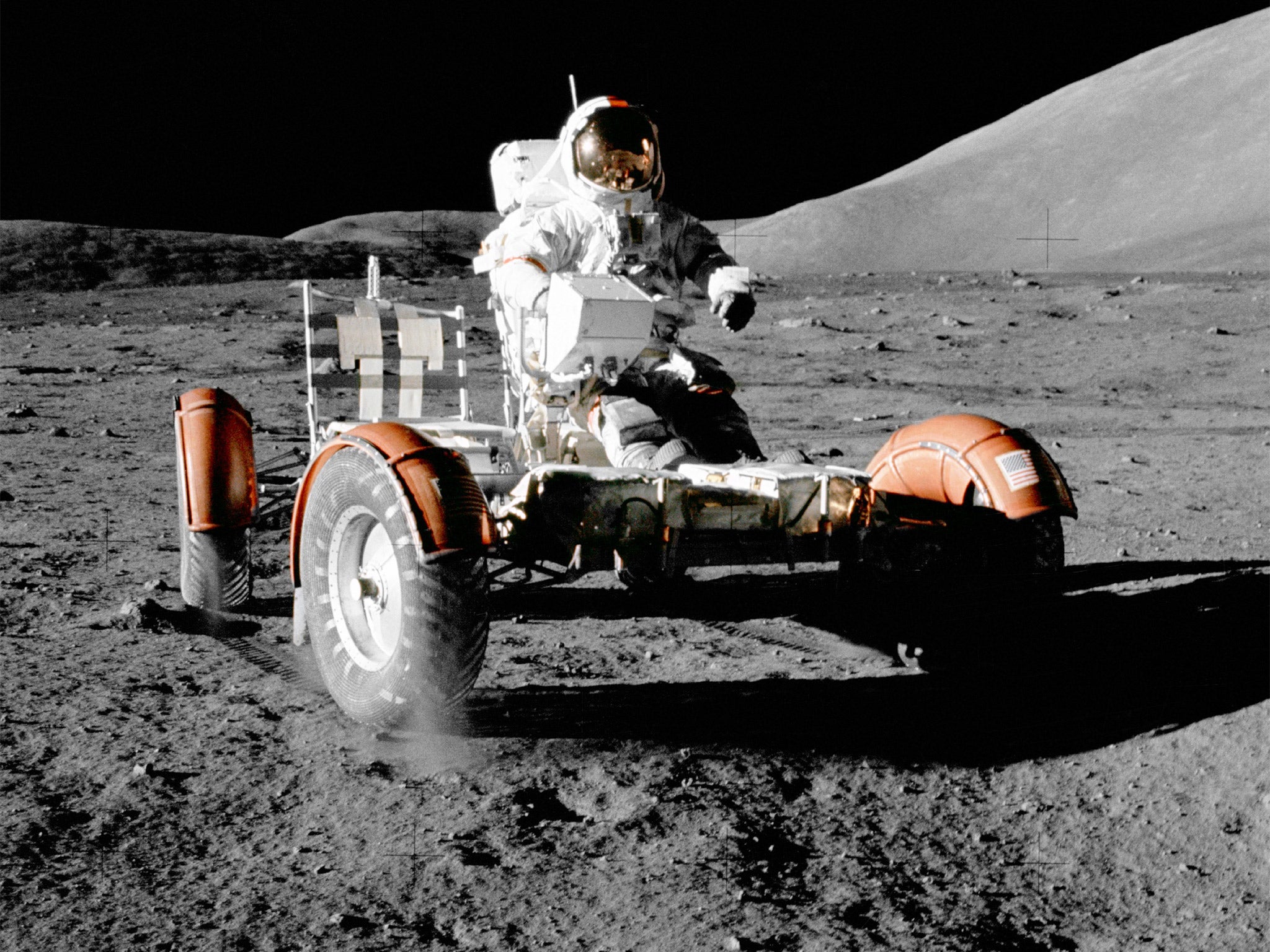 Eugene Cernan drives the lunar rover in the early part of the mission, prior to it being loaded with equipment