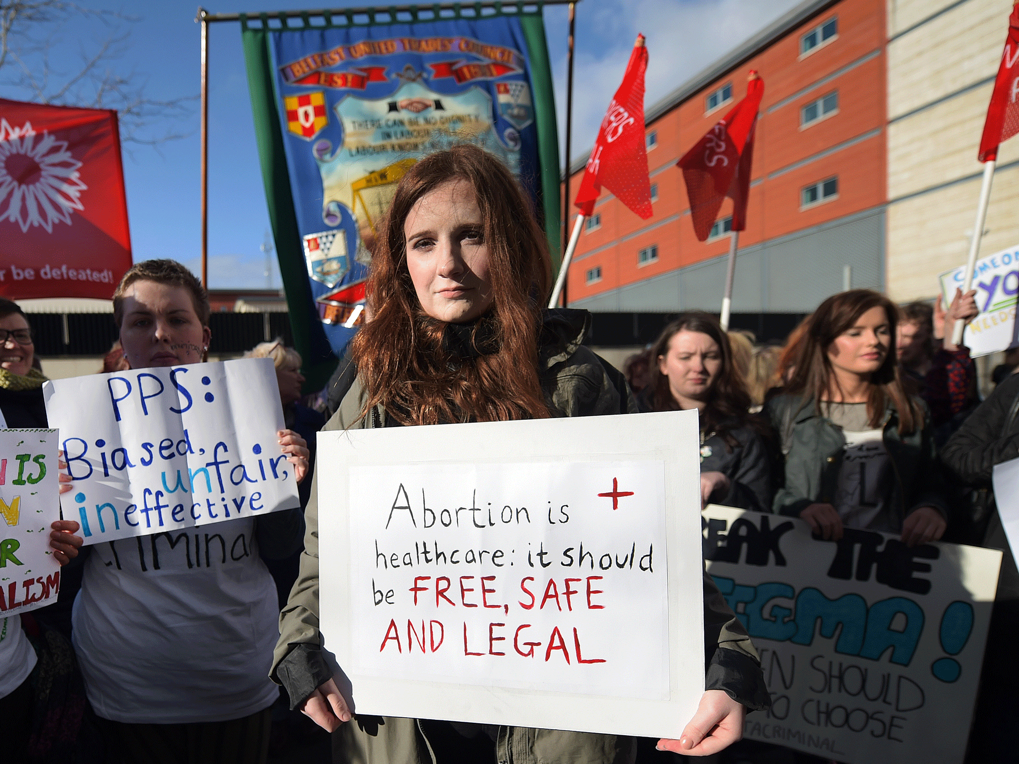 A pro-choice supporter carries a placard which reads 'Abortion is healthcare, it should be free, safe and legal'