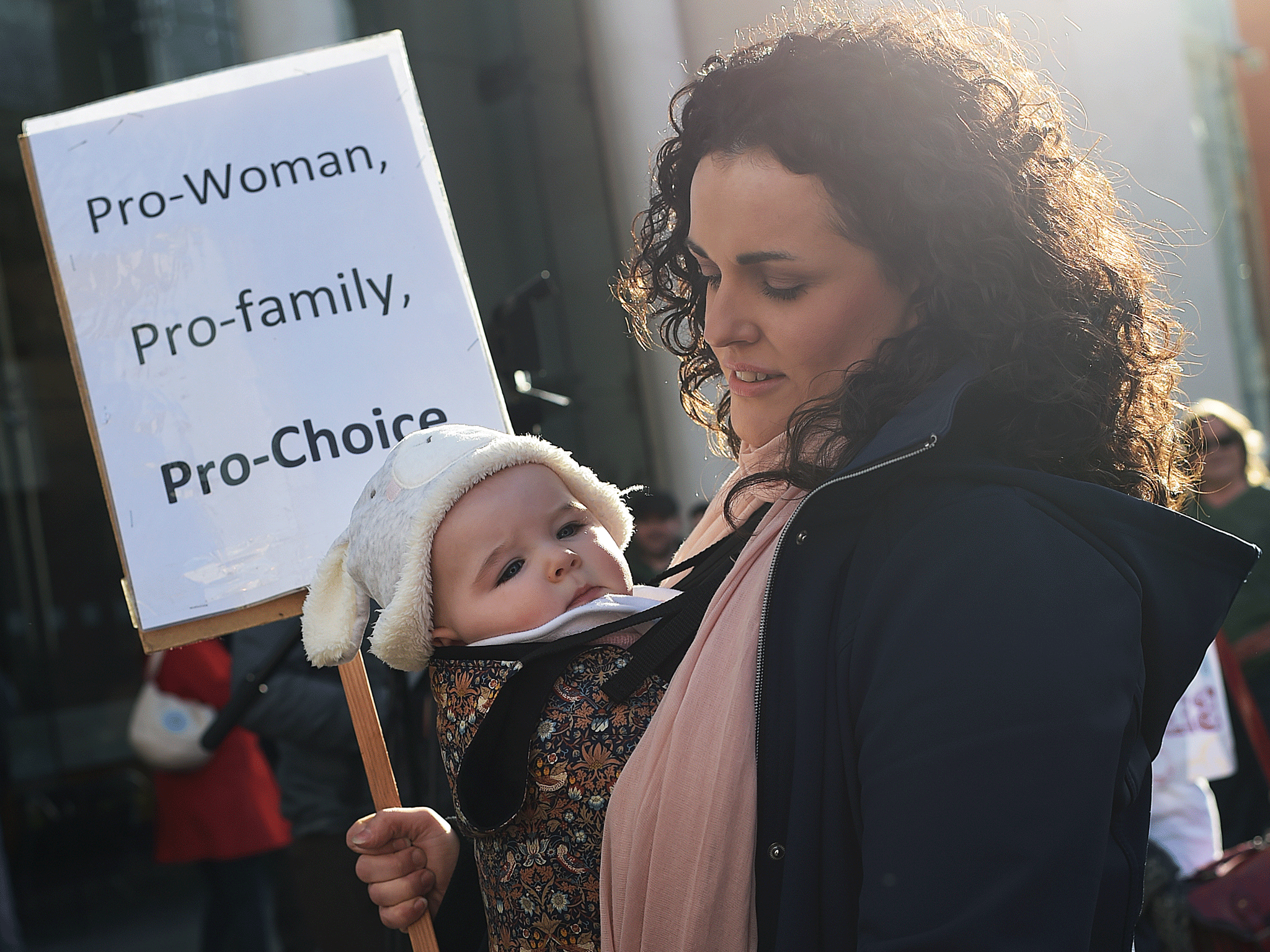 Local politician Gemma Weir from The Workers Party carries a placard which reads 'Pro woman, pro family, pro choice'