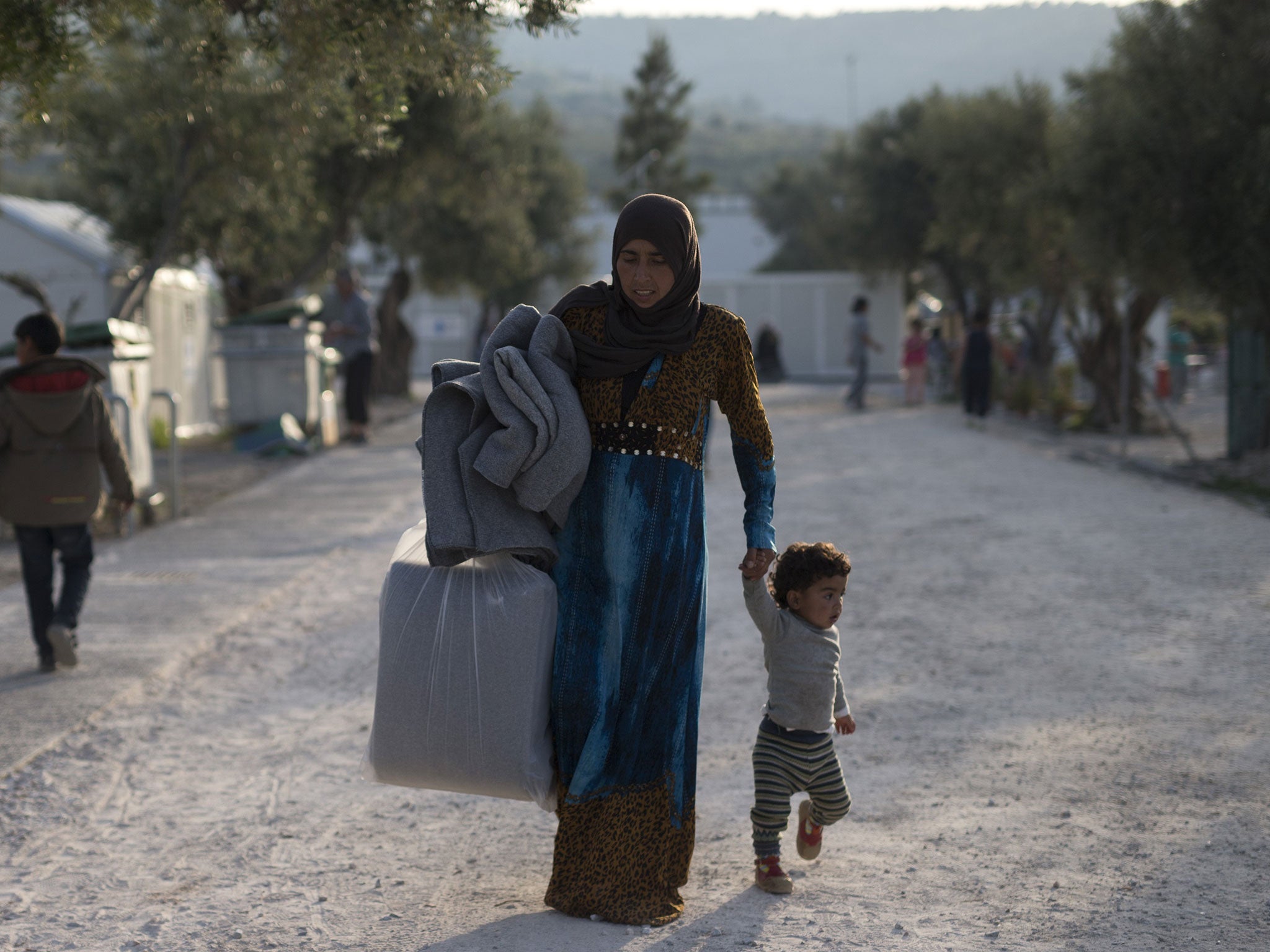 Refugees arrive at the Moria camp, where Pakistani men are hunger striking in protest at the threat of deportation