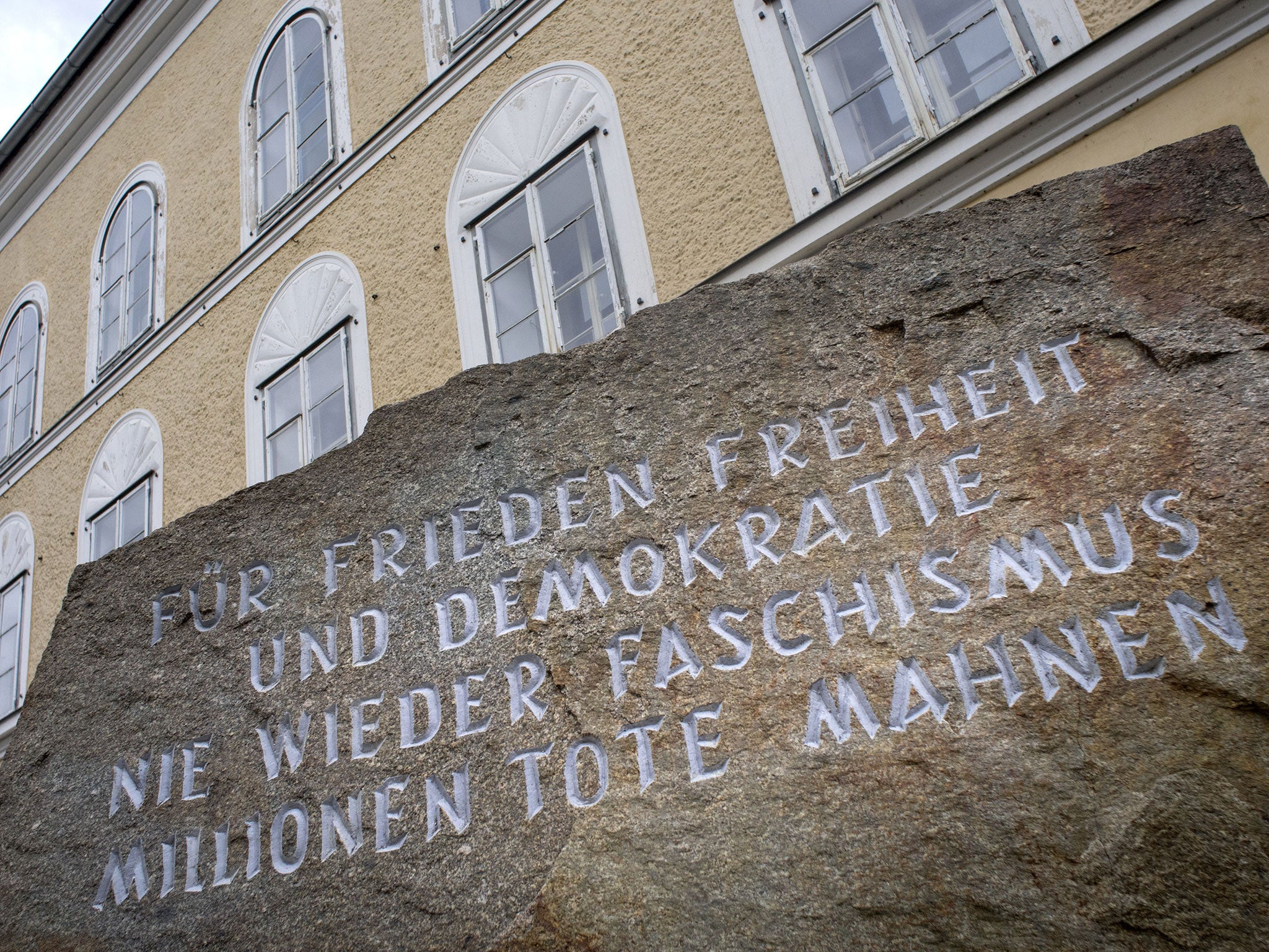 A memorial stone stands outside the house where Adolf Hitler was born in Braunau Am Inn, Austria