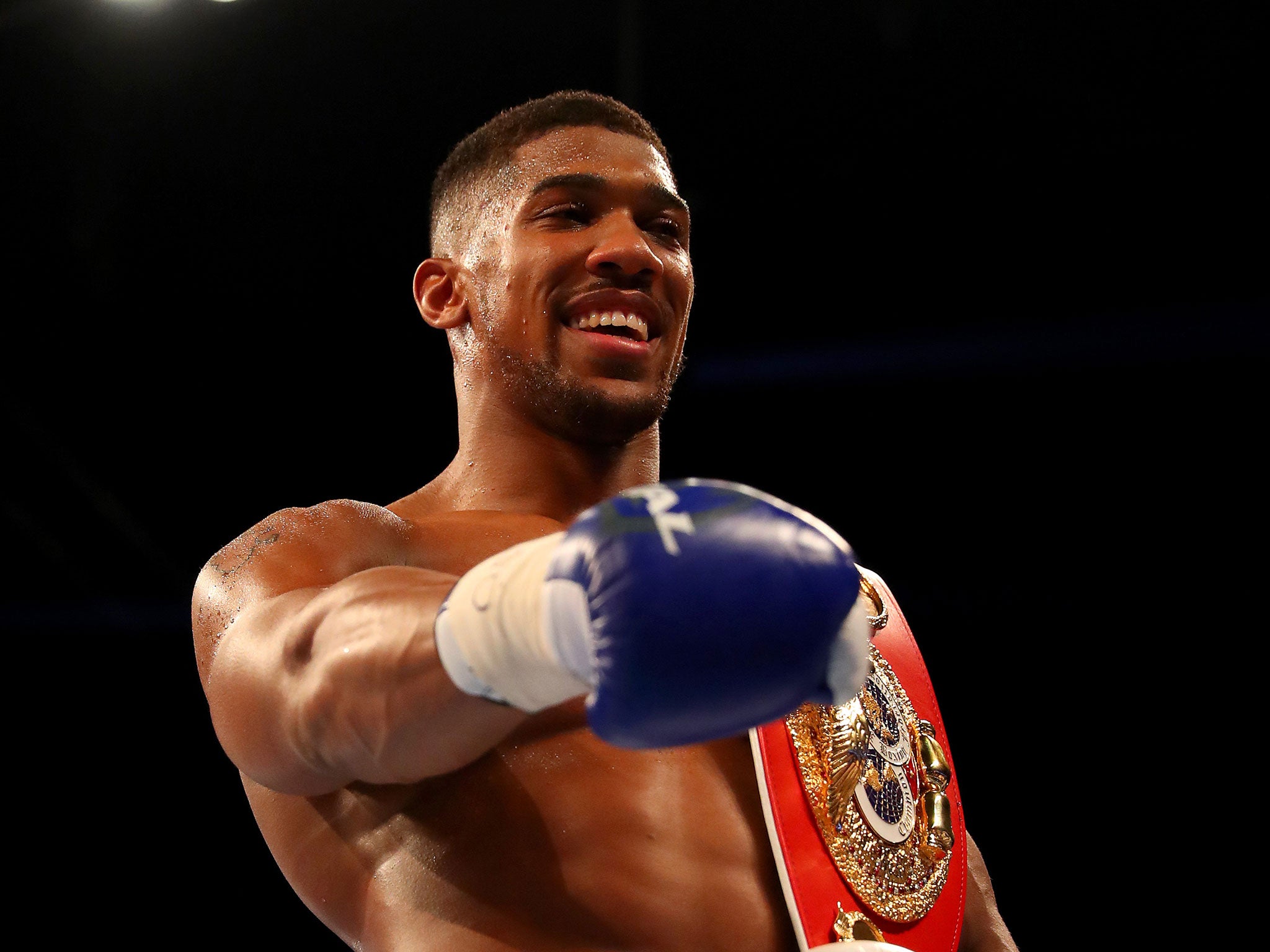 Anthony Joshua celebrates his IBF title win over Charles Martin