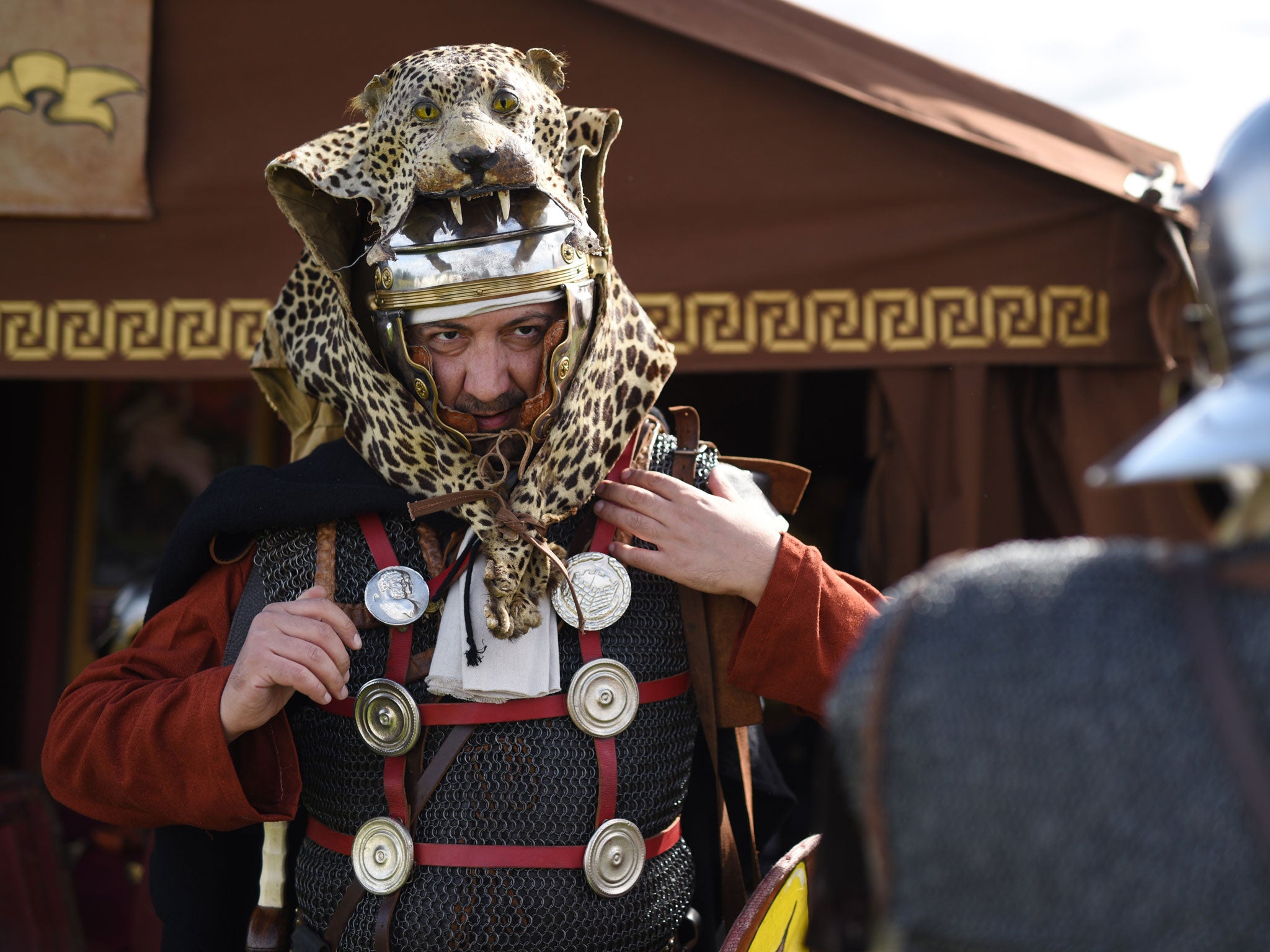 A man prepares for an Imperial Roman Army battle re-enactment at Hadrian's Wall in September 2015