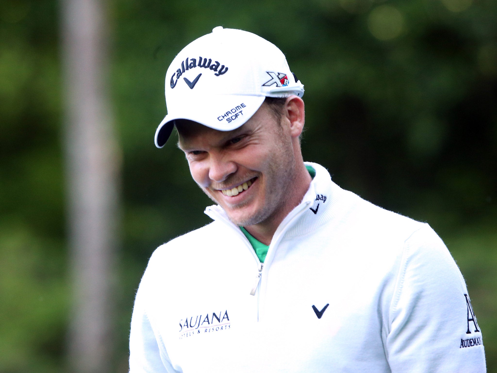 Danny Willett smiles after making a birdie putt on the 14th