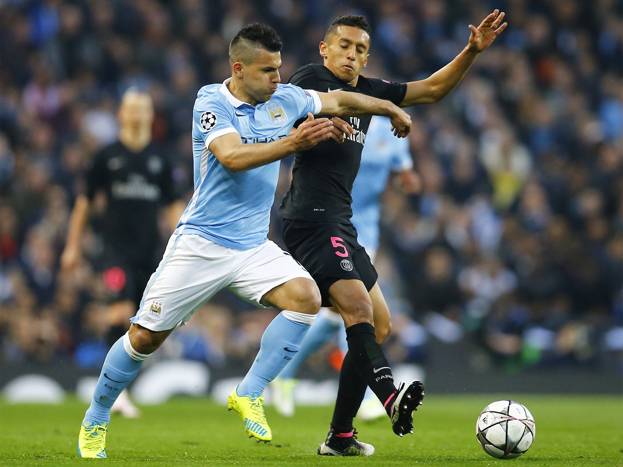 Sergio Aguero battles Marquinhos for the ball