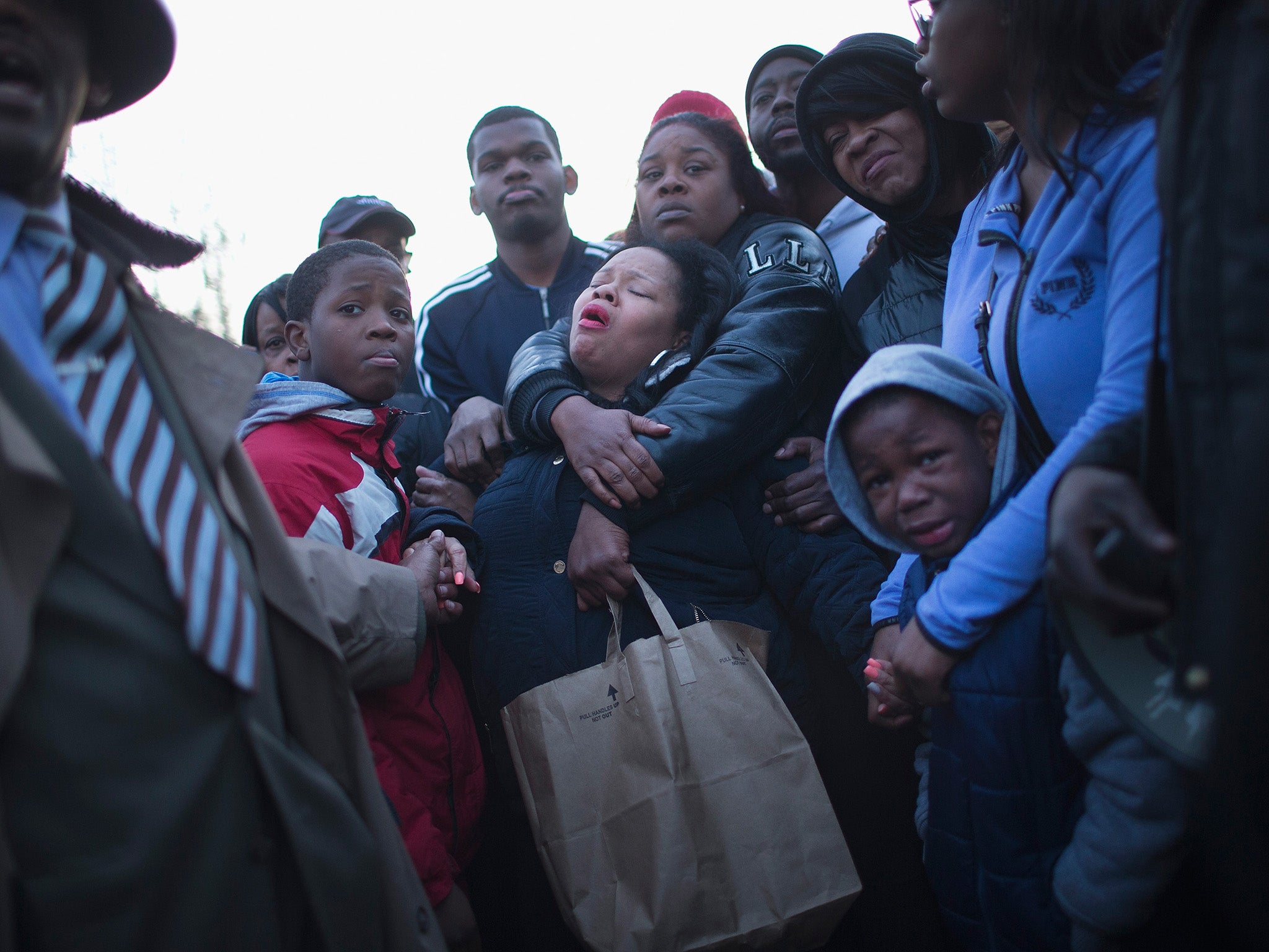 Tambrasha Hudson is comforted as she joins demonstrators protesting the shooting death of her son 16-year-old Pierre Loury