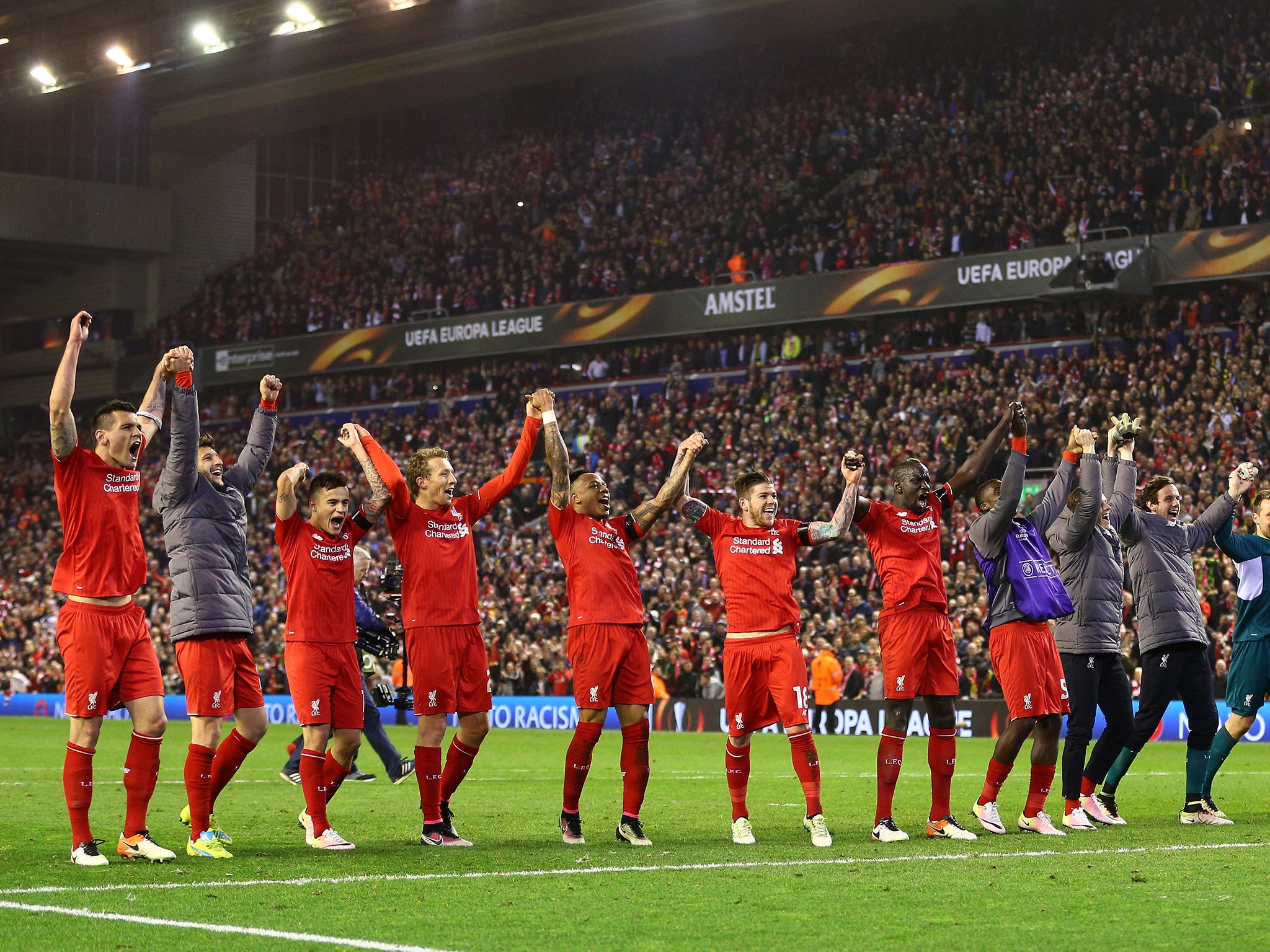 Liverpool players celebarate in front of the Kop at full time