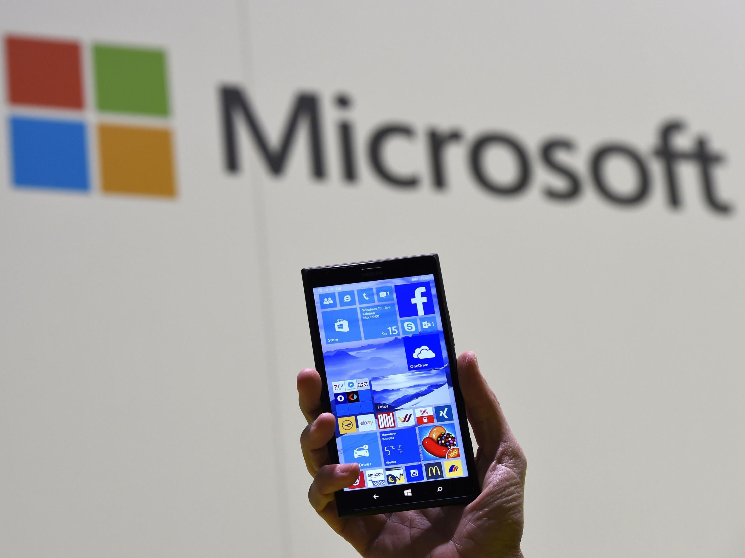 A man shows Microsoft's Windows 10 operating system at the CeBIT technology fair in Hanover