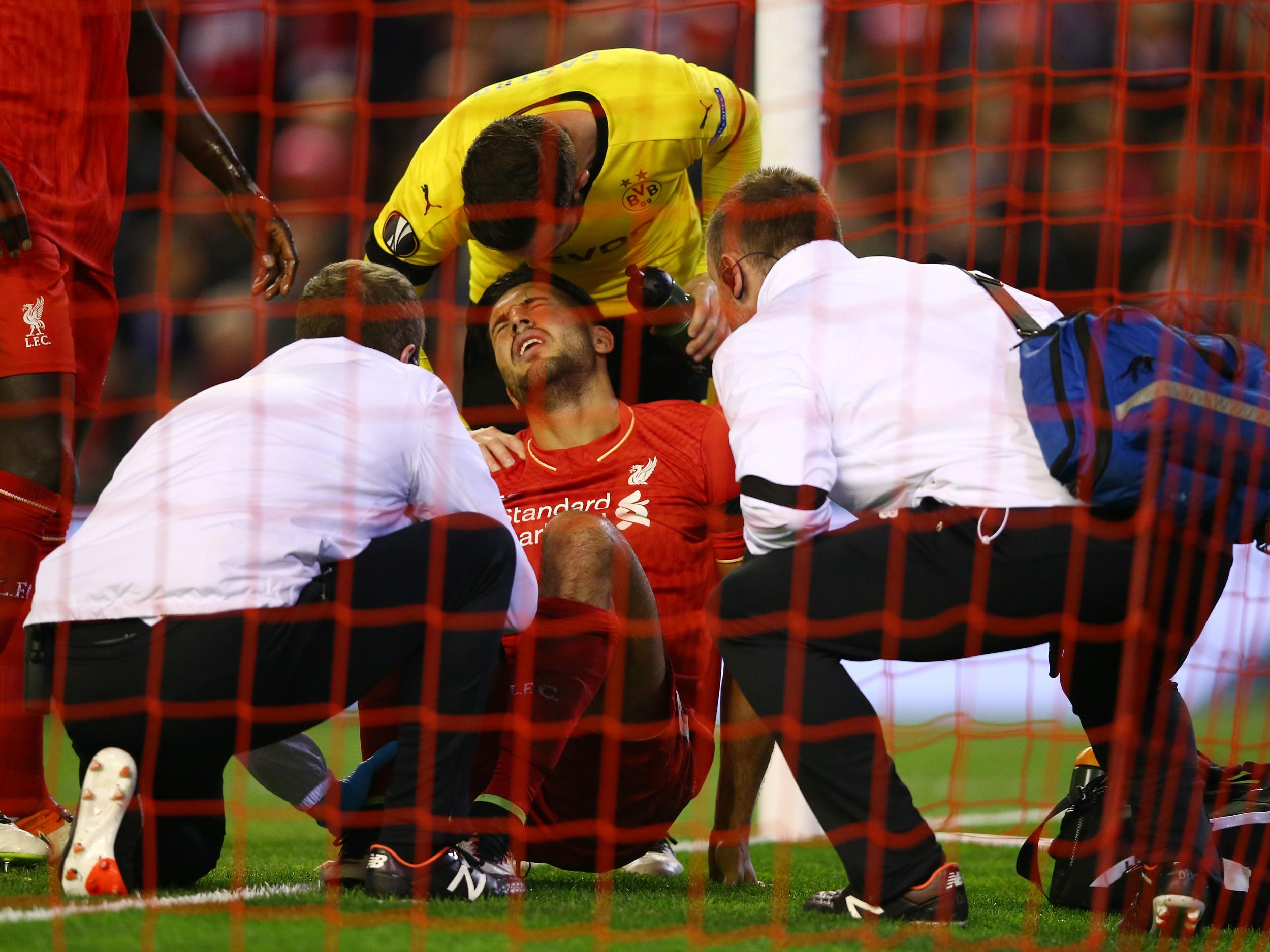 Emre Can receives treatment during the match against Dortmund