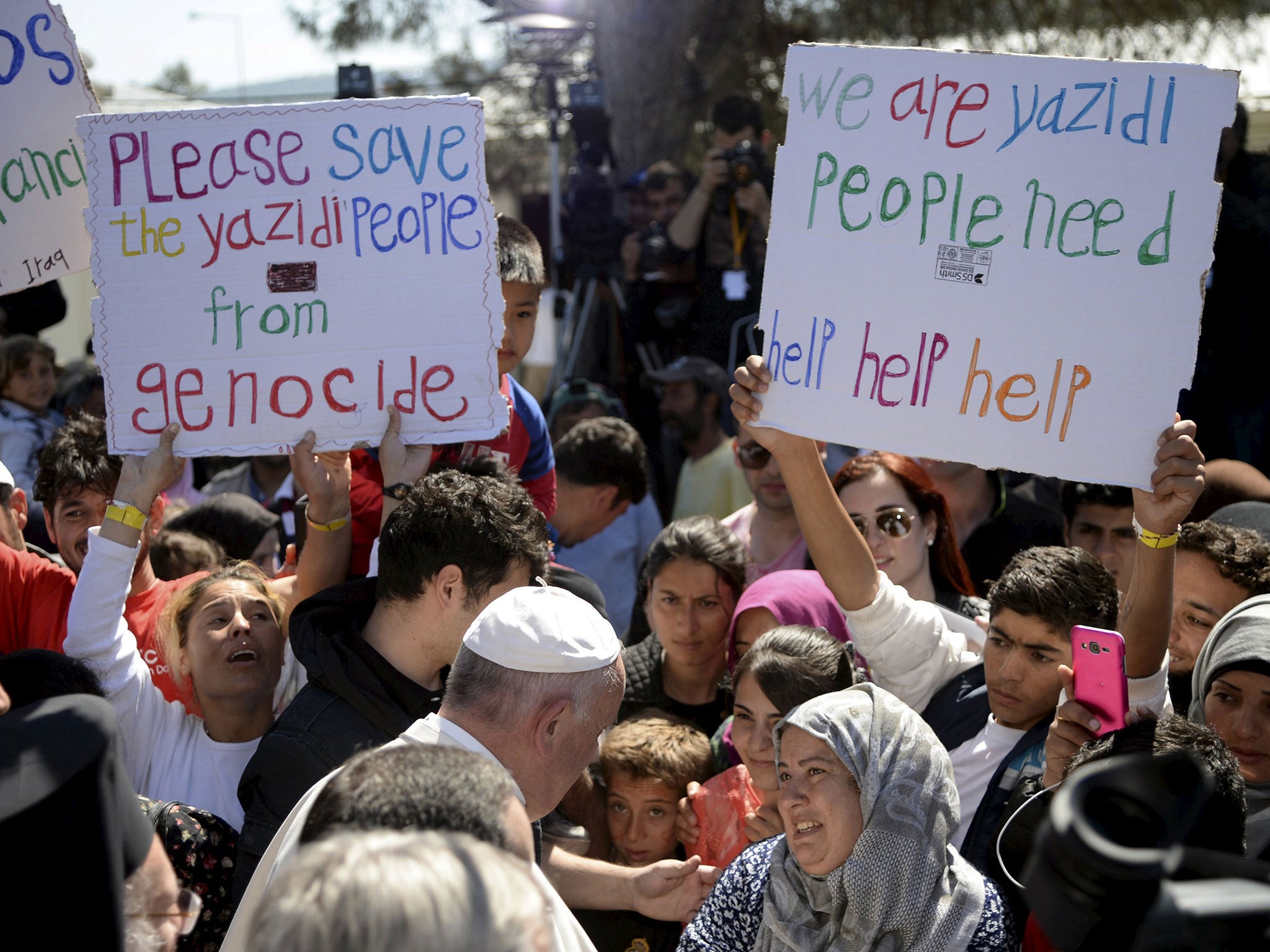 Pope Francis greets migrants and refugees at the Moria refugee camp on the Greek island of Lesbos, April 16, 2016.