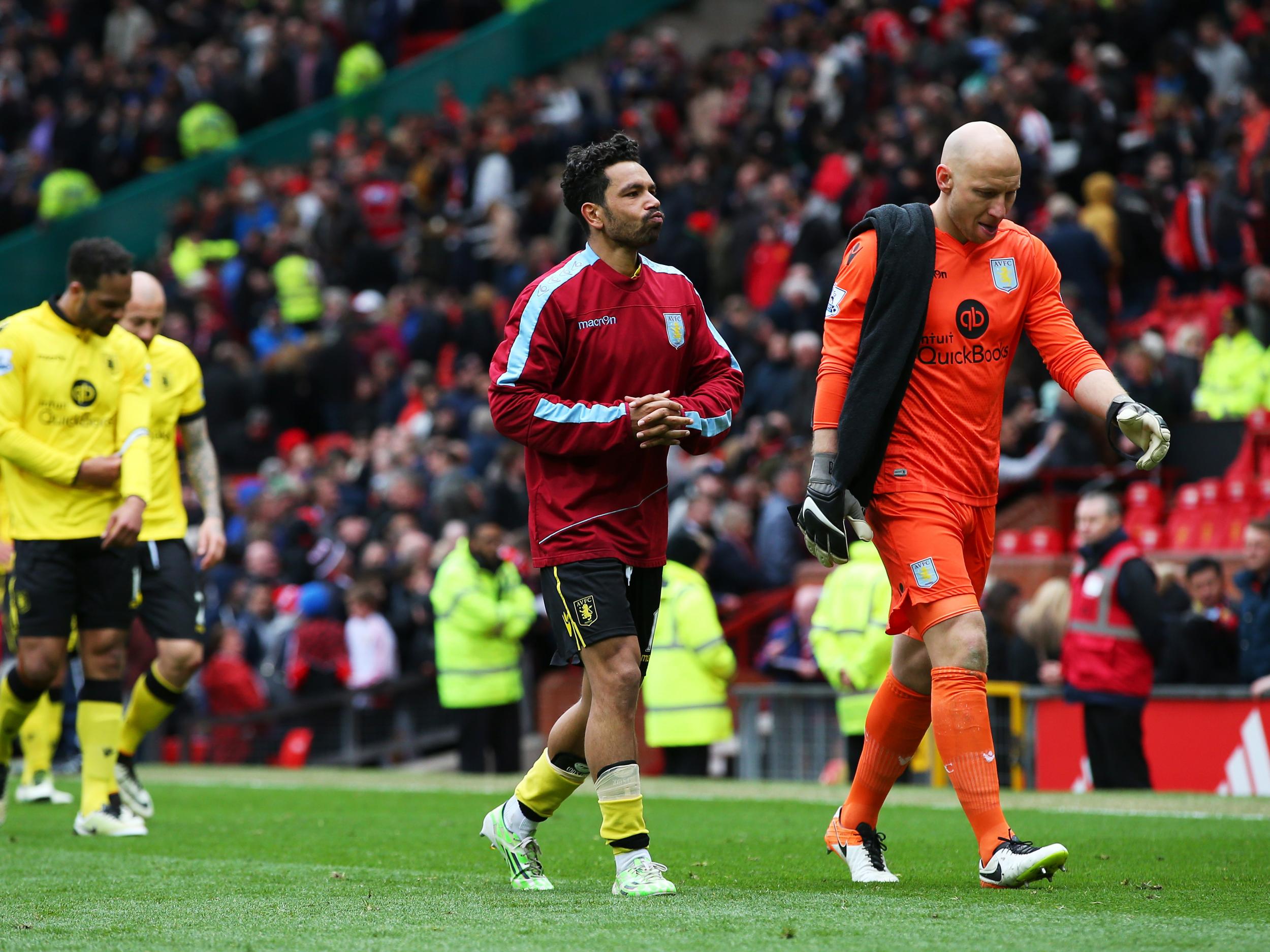 Aston Villa players trudge off the Old Trafford pitch after relegation