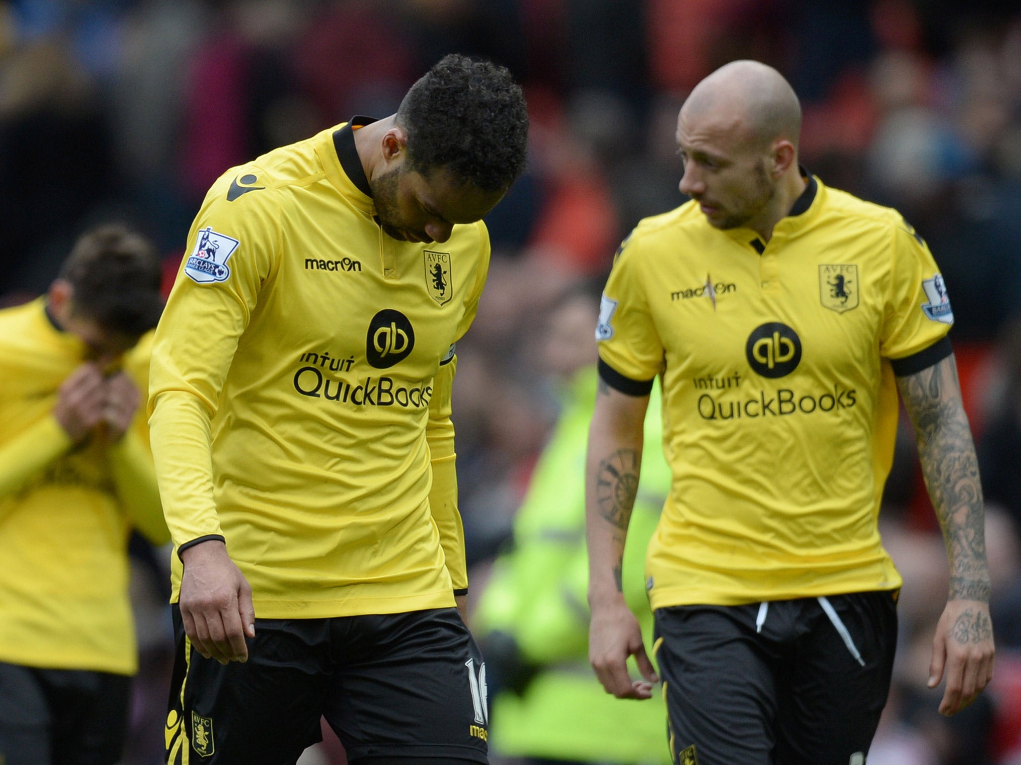 Joleon Lescott and Alan Hutton leave the field after Aston Villa's relegation is confirmed