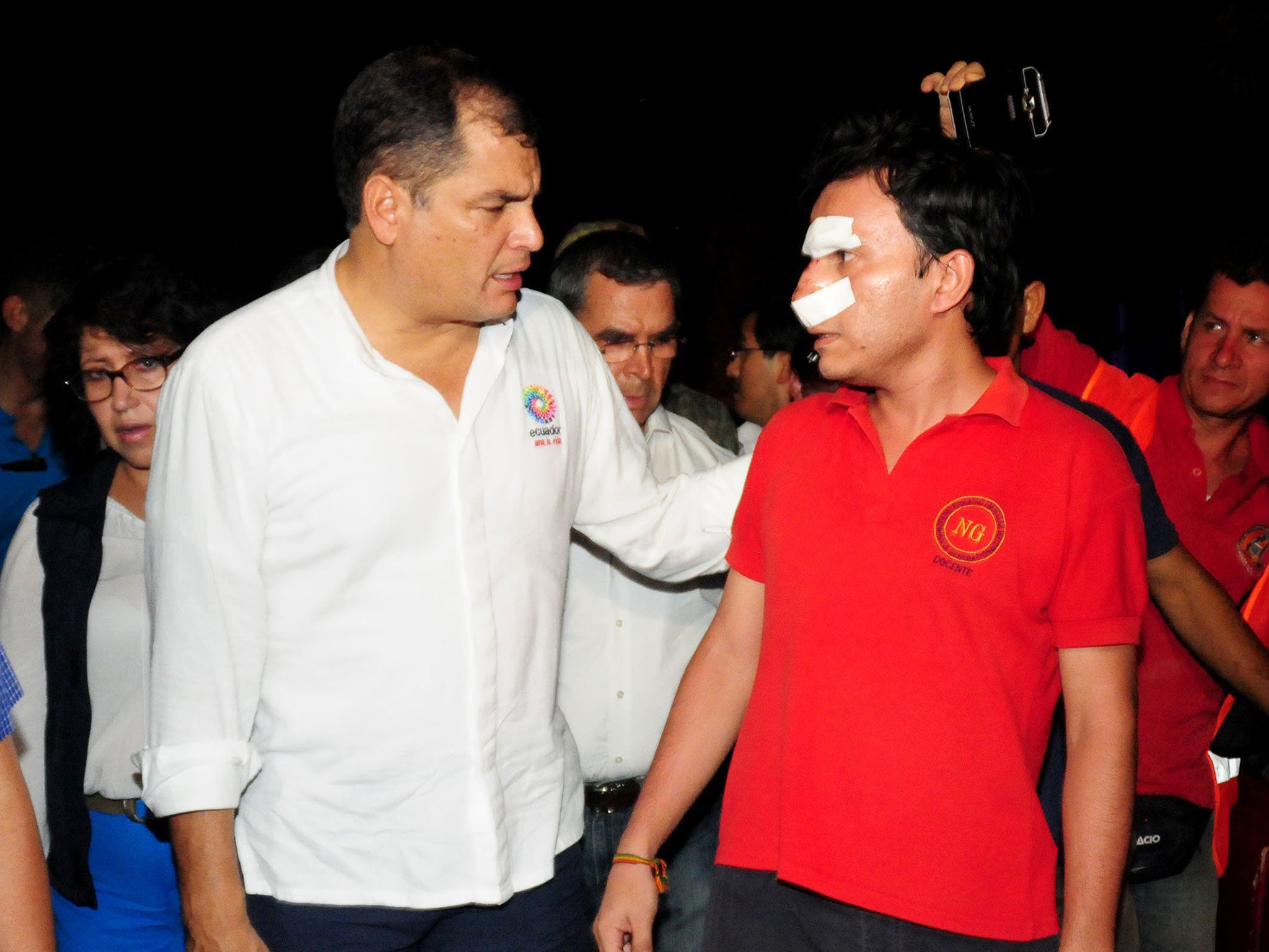 Ecuador's President Rafael Correa (L) talking to a wounded man during his visit to the city of Manta, Ecuador, on April 17, 2016 a day after a powerful 7.8-magnitude quake hit the country