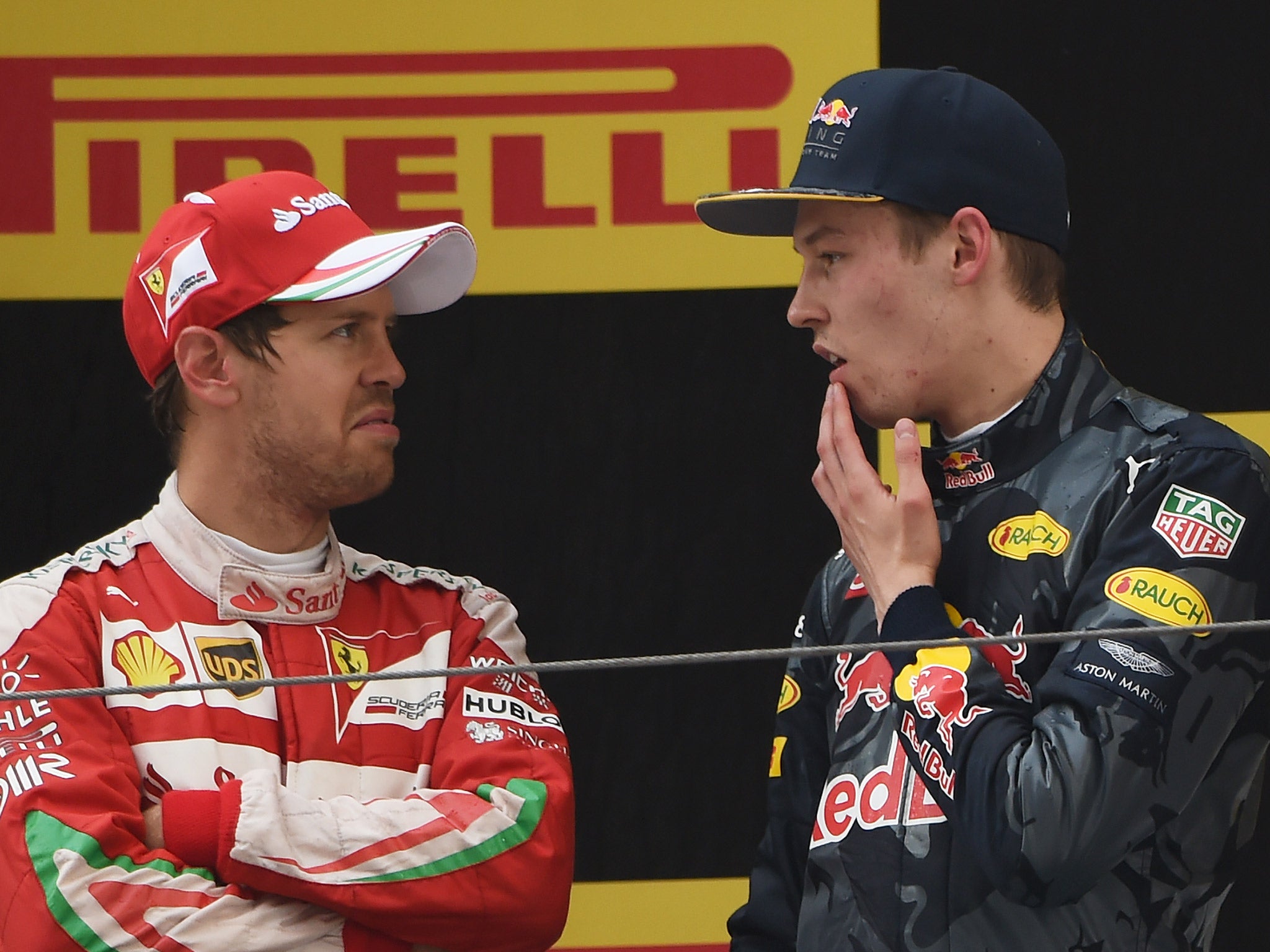 Sebastian Vettel speaks with Daniil Kvyat on the podium after the Chinese Grand Prix