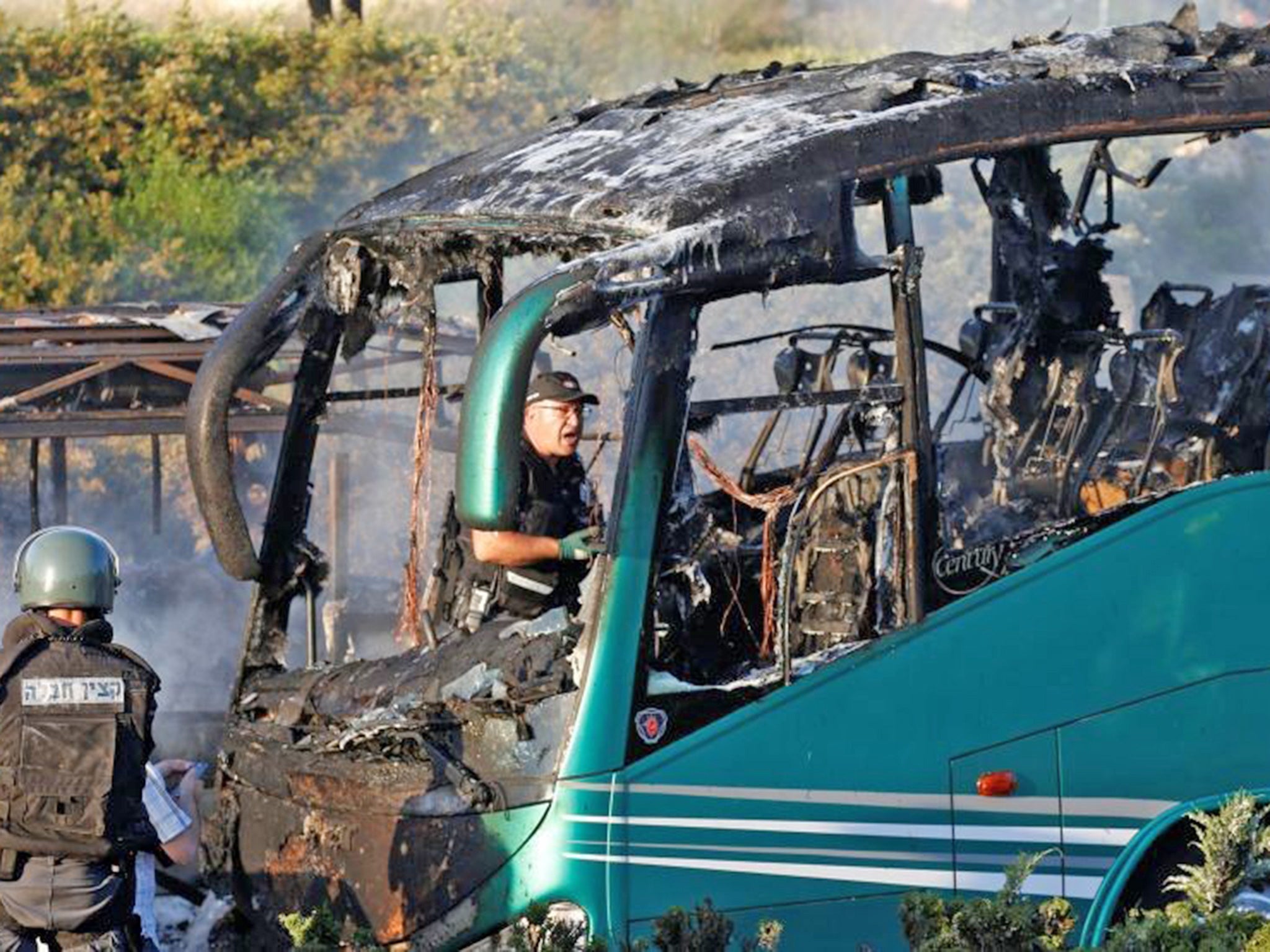 Emergency workers search the scene after a blast on a bus in Jerusalem
