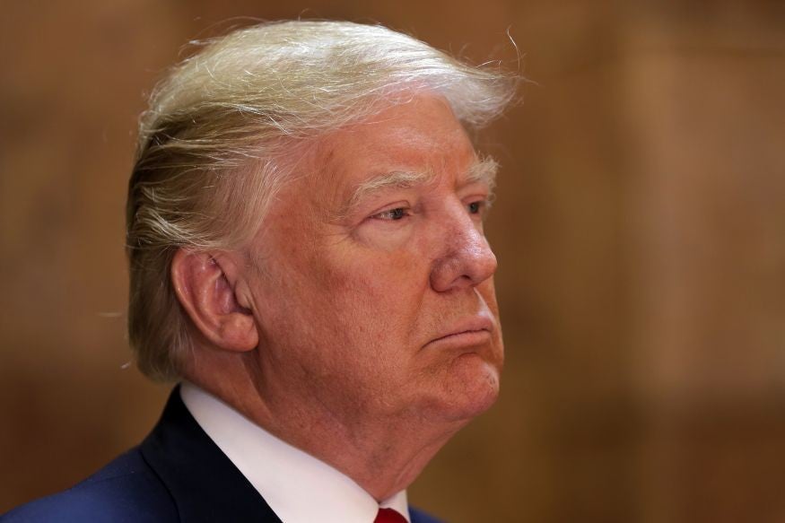 Republican presidential candidate Donald Trump listens to introductory remarks before speaking in New York's Trump Tower building.