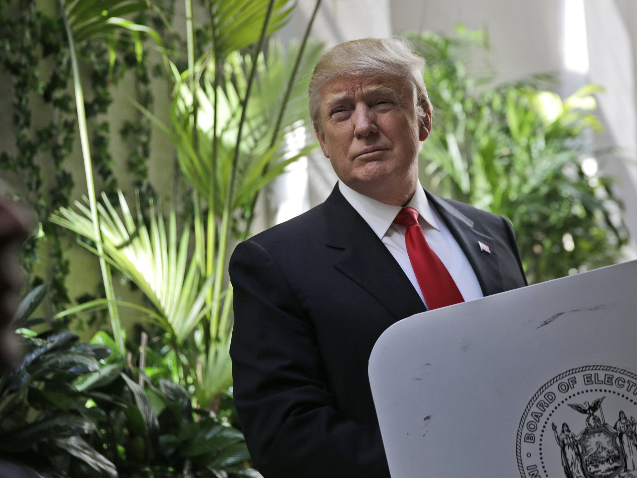 Donald Trump fills in his ballot during the New York primaries AP