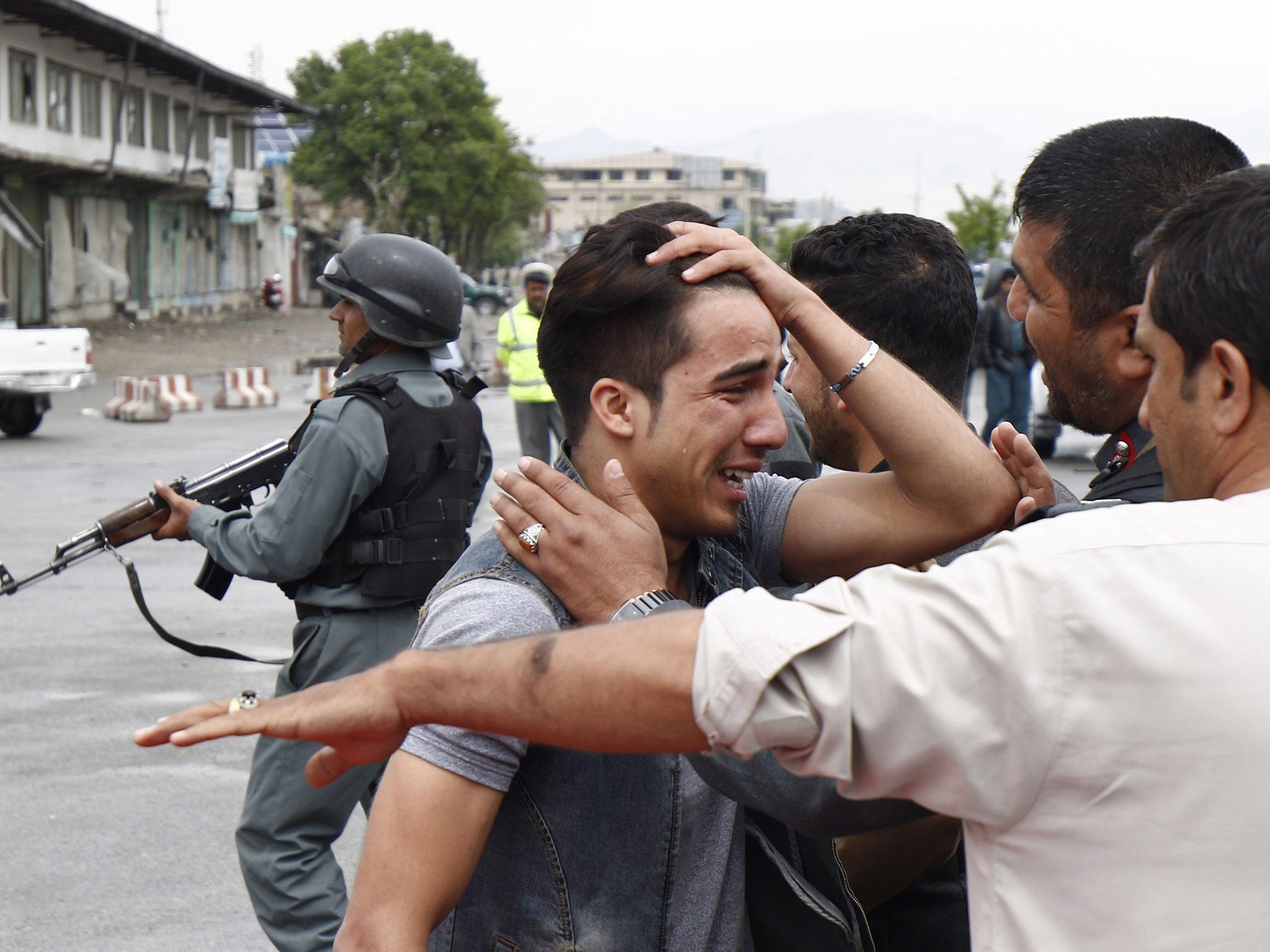 An relative of one of the victims who was killed in a suicide bomb blast in Kabul, Afghanistan, 19 April 2016.