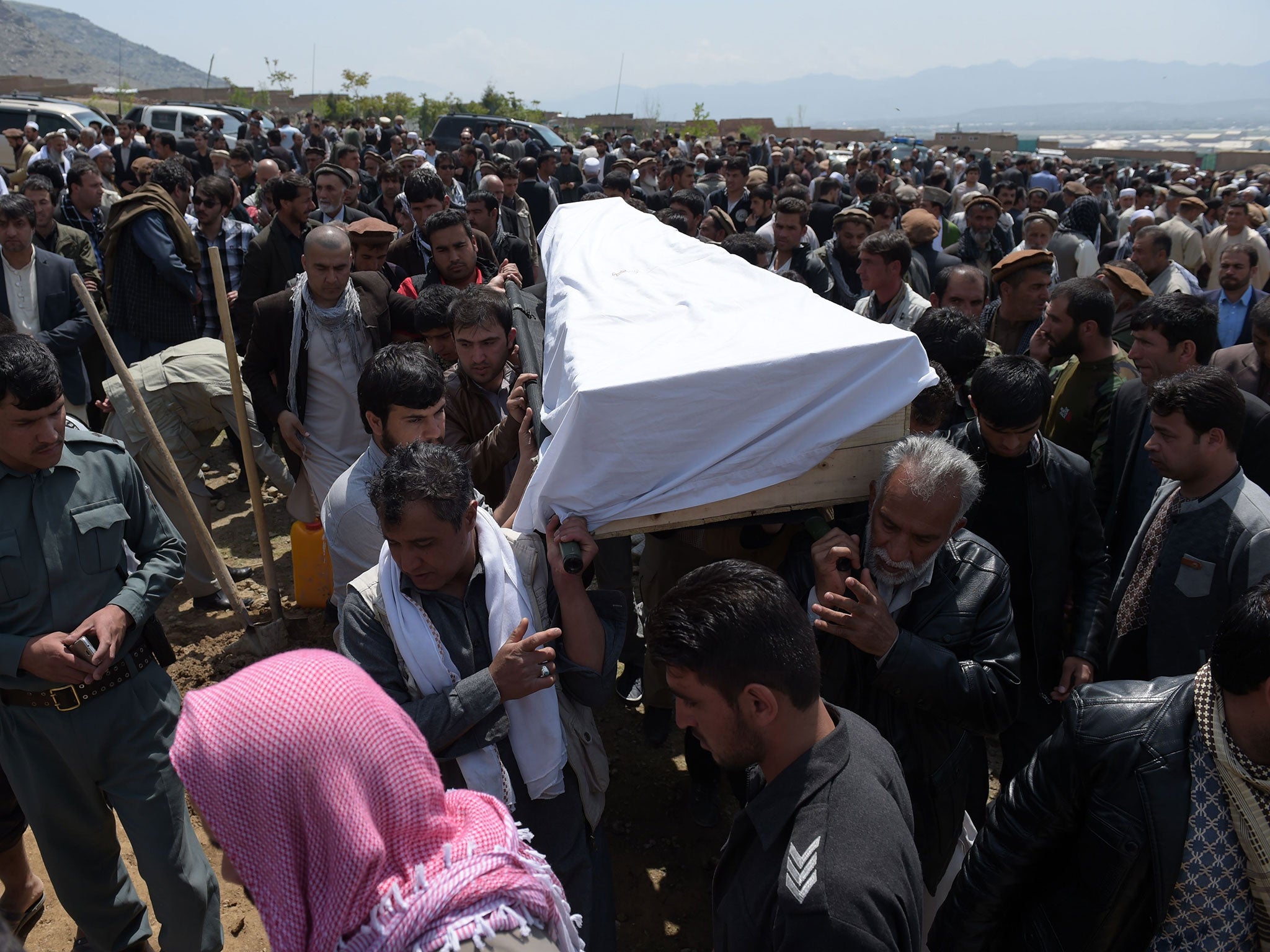 Relatives and loved ones carry the coffin of a victim killed in the April 19 Taliban truck bomb attack, at a funeral in Kabul on April 20, 2016.