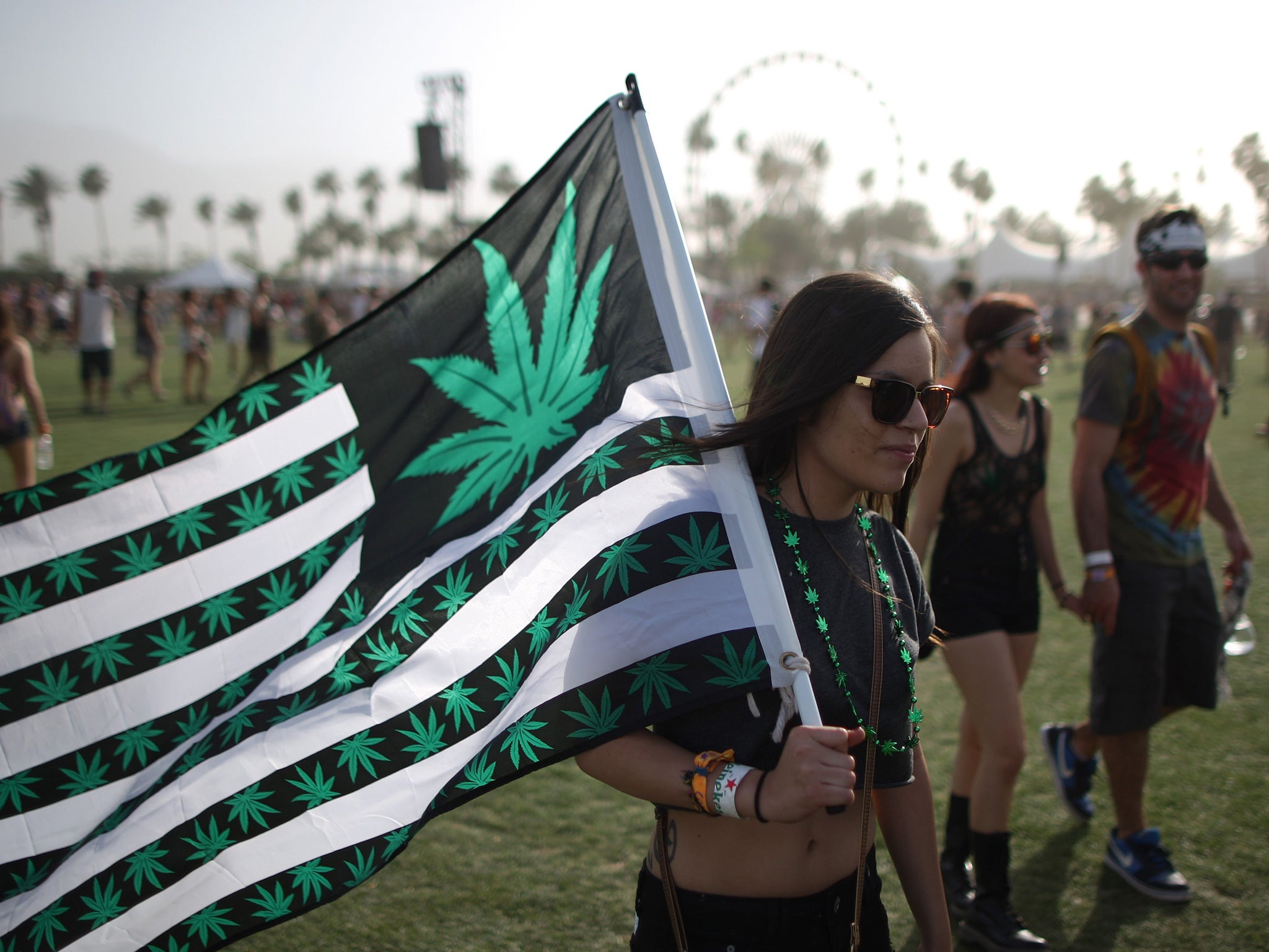 Woman carries cannabis flag at Coachella David McNew/Getty