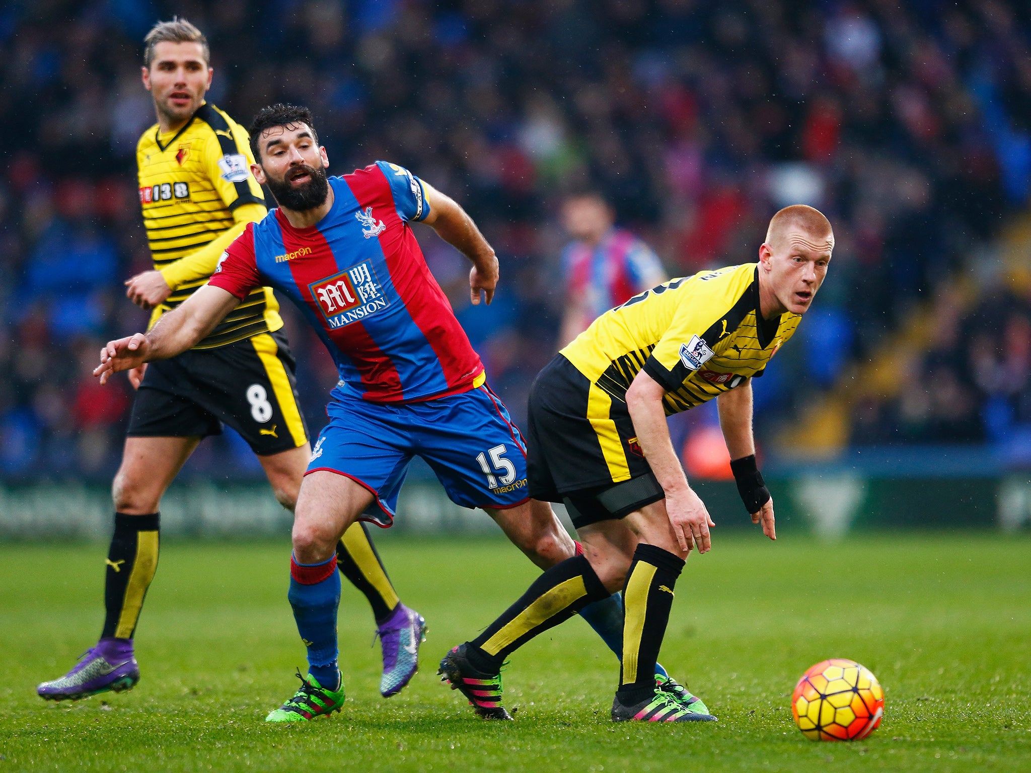 Mile Jedinak and Ben Watson battle for the ball