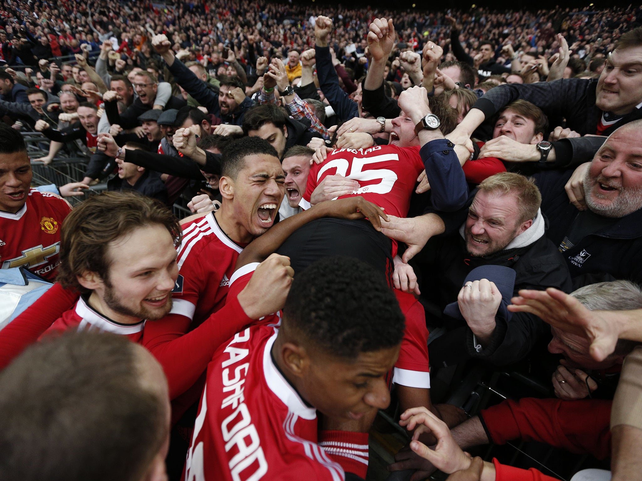 United players celebrate with their fans after Martial's late winner