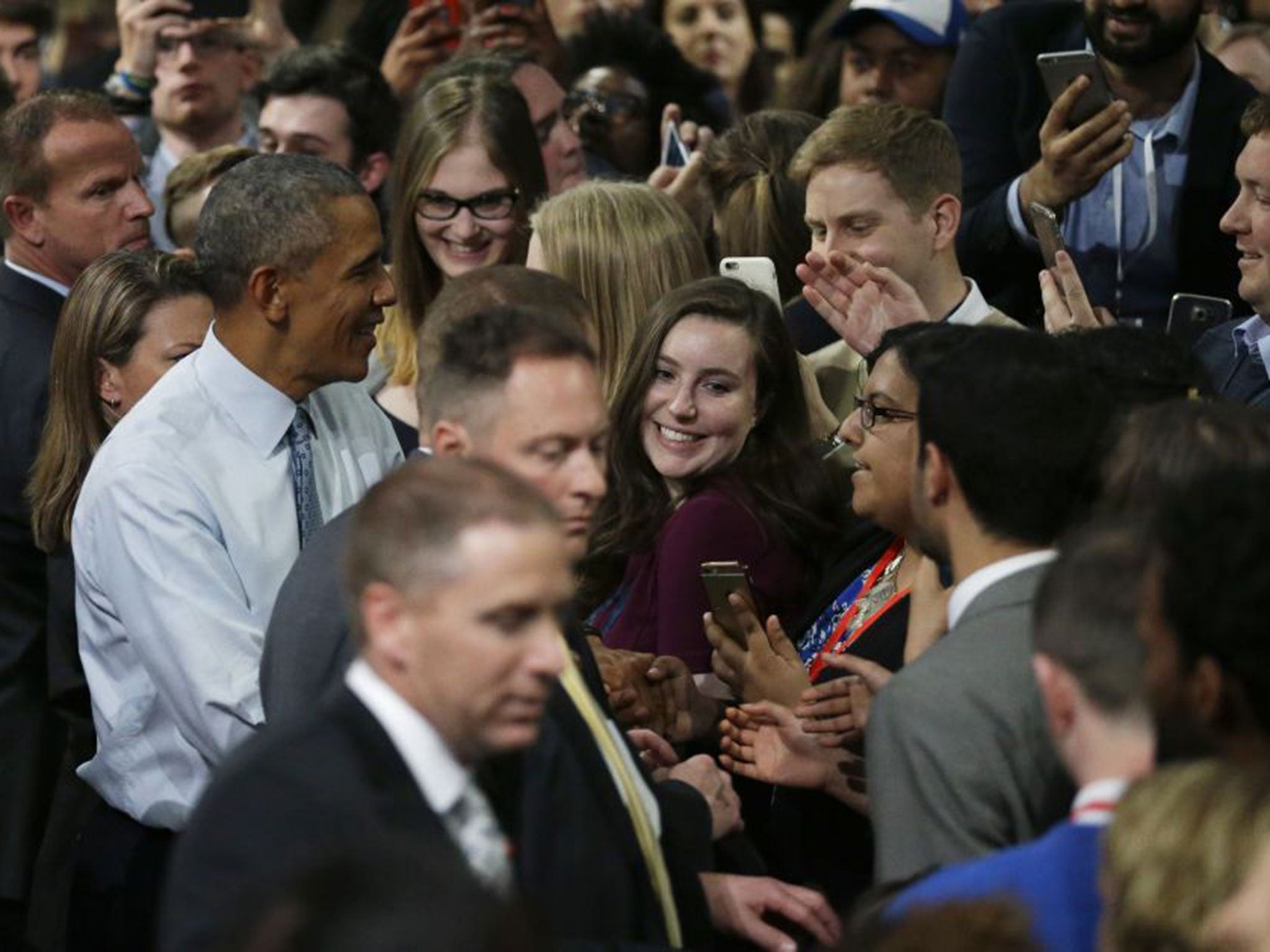 Barack Obama spoke personally to Maria Munir, centre, wearing glasses, at the cessation of the meeting