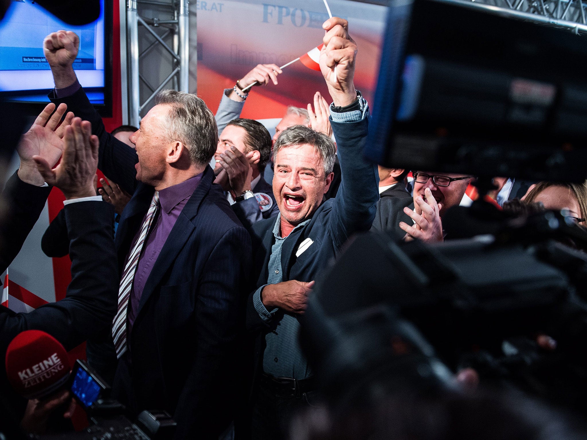 Members of the right-wing Austrian Freedom Party (FPOe) celebrate at the party headquarters during presidential elections in Vienna, 24 April 2016