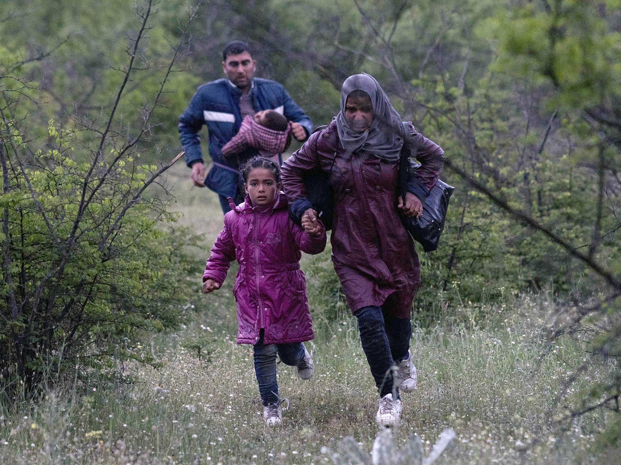 A Syrian family run in a forest in Macedonia after illegally crossing Greek-Macedonian border near the city of Gevgelija. Some 50,000 people, many of them fleeing the war in Syria, have been stranded in Greece since the closure of the migrant route through the Balkans in February