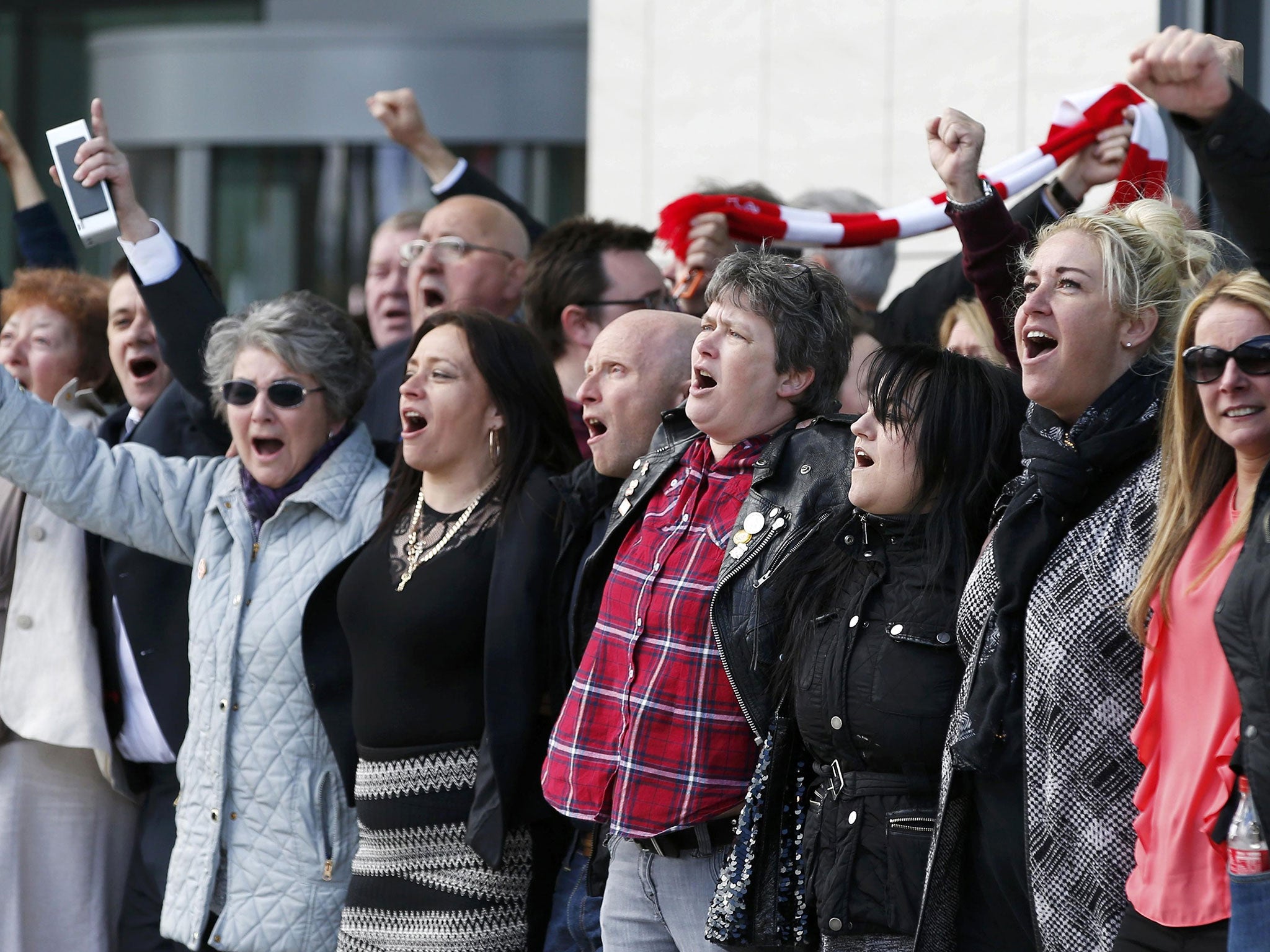 &#13;
Relatives sing "You'll never walk alone" outside the courtroom &#13;