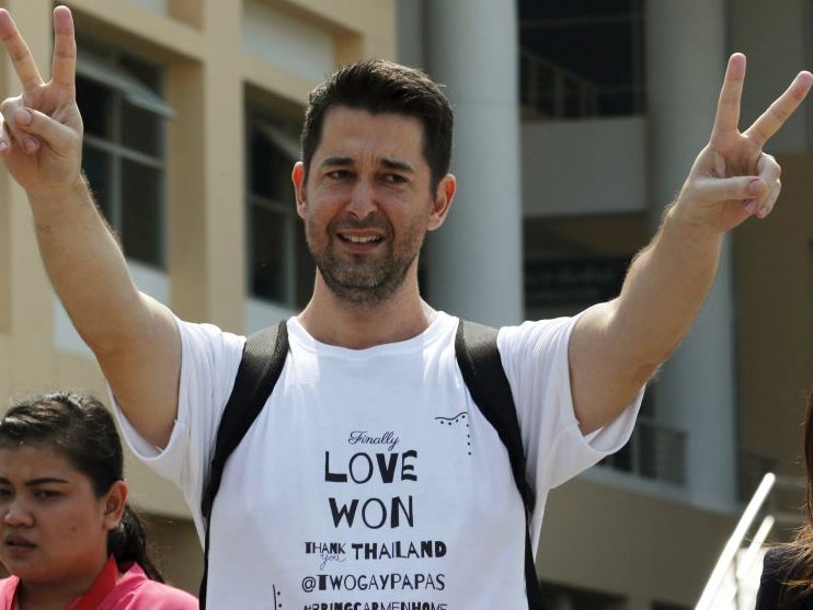 Manuel Santos from Spain gestures as he leaves the Central Juvenile and Family Court, in Bangkok, Thailand