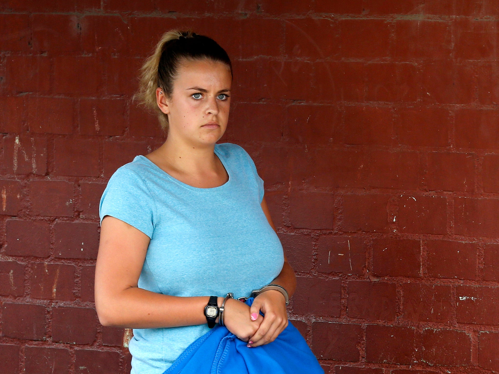 Melissa Reid, cuffed, arrives at court at Sarita Colonia prison in Callao December 17, 2013