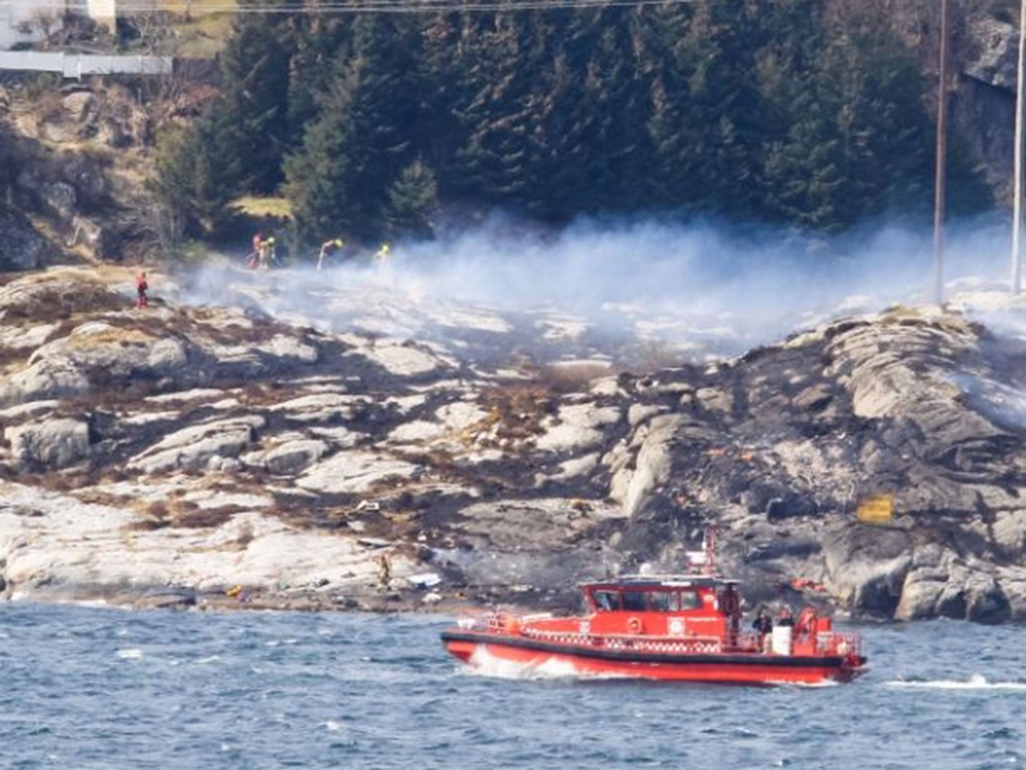 Rescue forces work at the shore west of Bergen, Norway after a helicopter transporting 13 workers from an offshore oil field in the North Sea crashed on 29 April, 2016