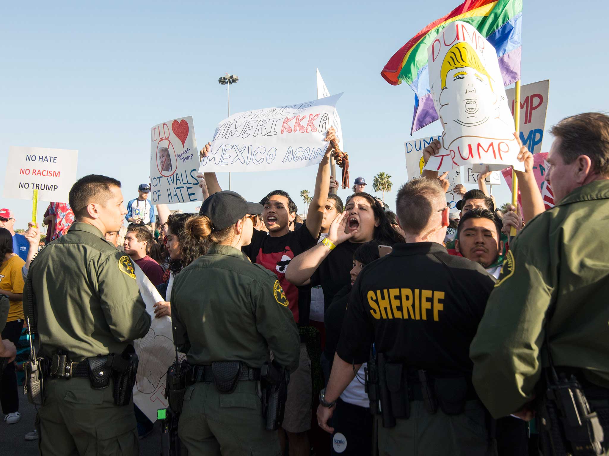 Protesters demonstrate at Donald Trump rally at The Pacific Amphitheatre in Costa Mesa, California