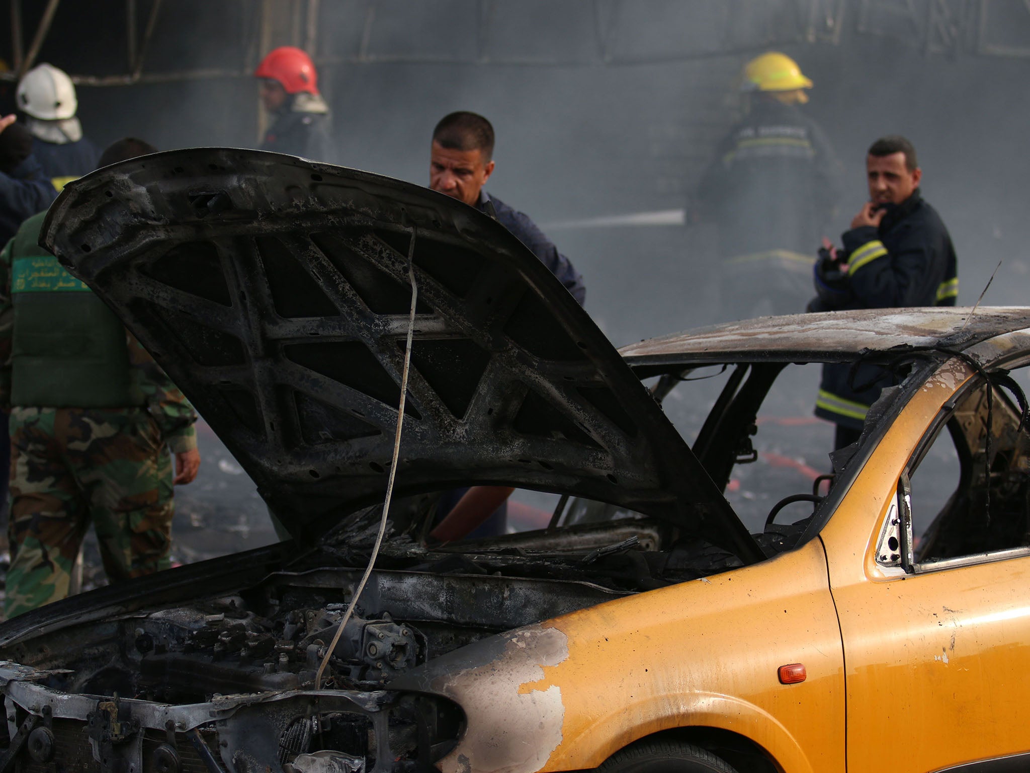 Iraqi security forces secure the site of an earlier suicide bombing in the Baghdad Jadida area on April 25, 2016.