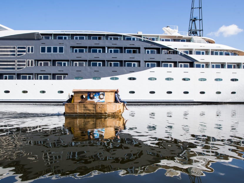 Kevin McCloud sailing in the cardboard houseboat on the River Thames