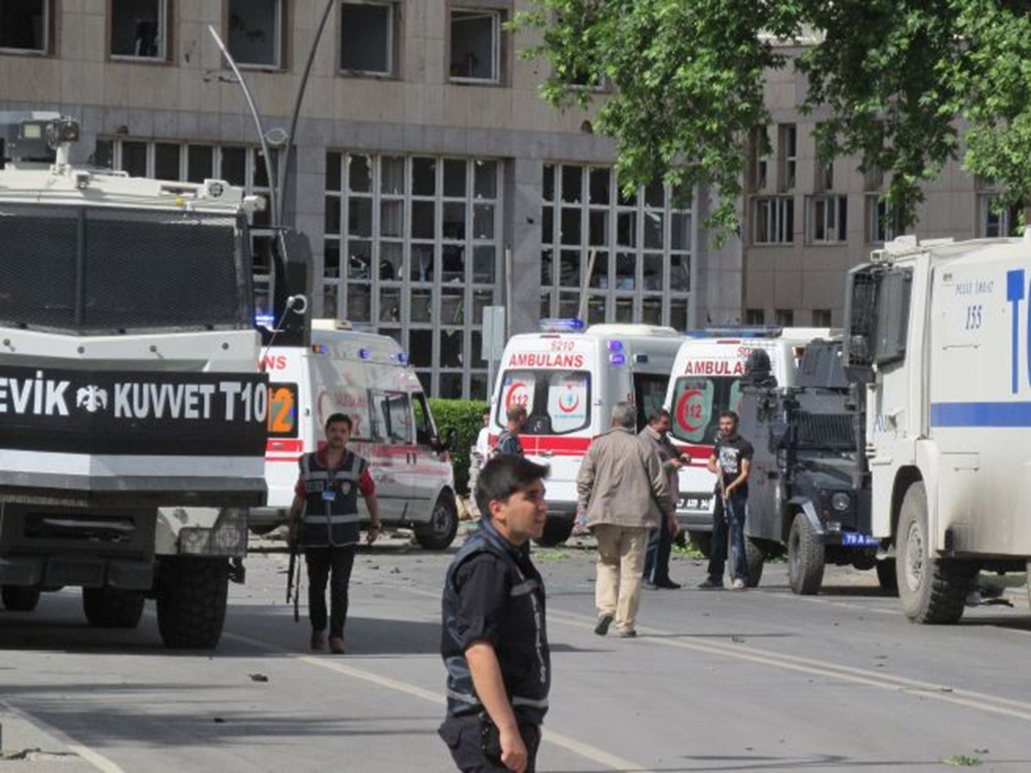 Police officers at the scene of the explosion - at least one person has been killed and another 13 injured