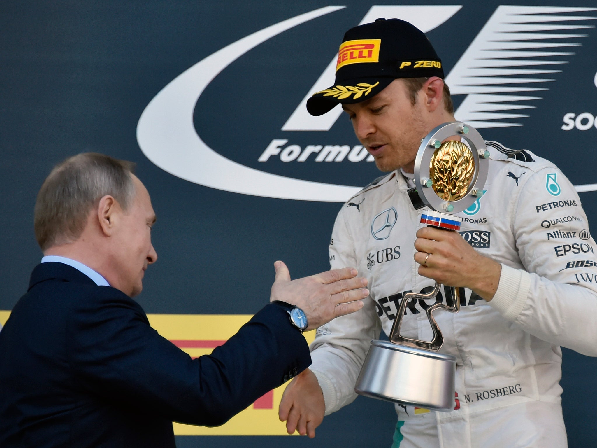 Nico Rosberg is presented with the race-winners' trophy by President Vladimir Putin